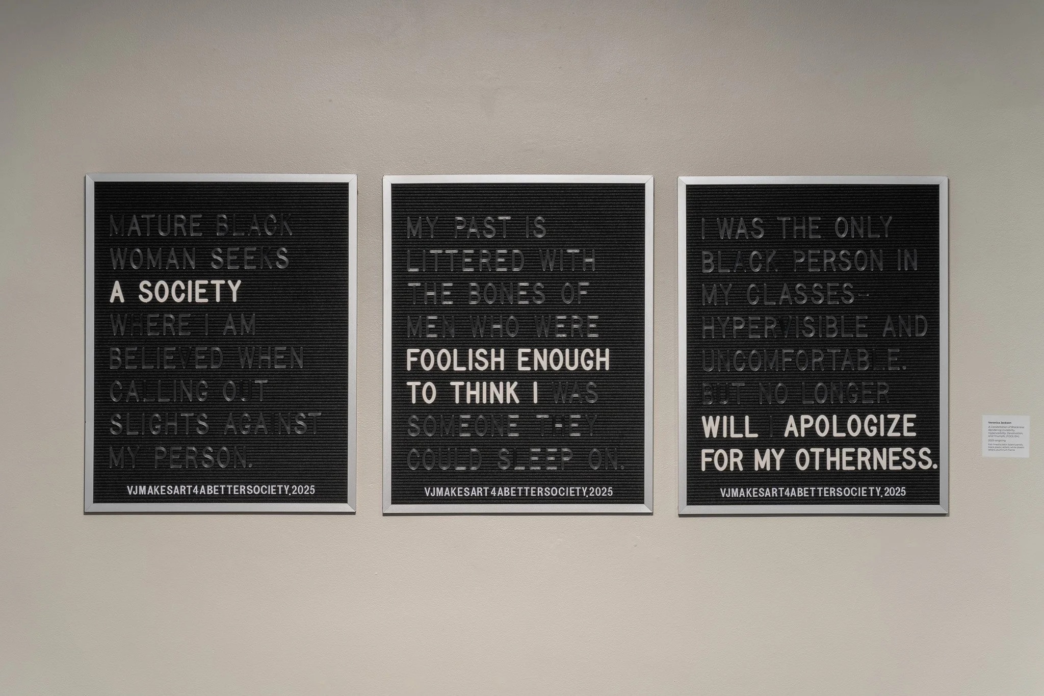 Veronica Jackson,  A Constellation of Blackness: Rendering Invisibility, Hypervisibility, Devaluation, and Triumph; (FOOLISH) , 2025-ongoing, felt-lined bulletin board panels, black plastic letters, white plastic letters, aluminum frame
