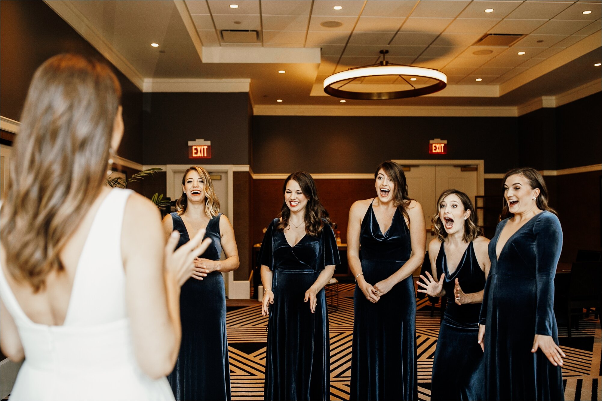  bride showing bridesmaids her in dress for the first time bridesmaid first look 