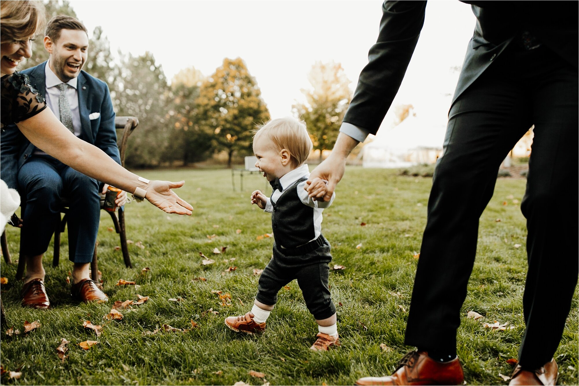  candid photo of little boy running across the aisle before wedding ceremony 
