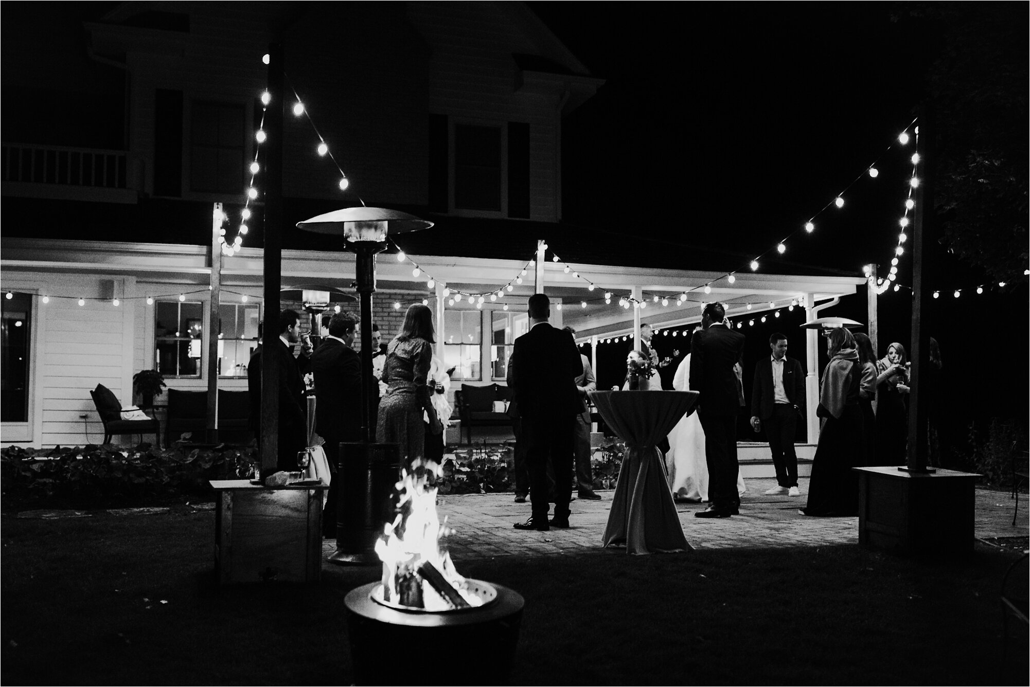  wedding reception nighttime lit with lights string lights dark wedding black and white 