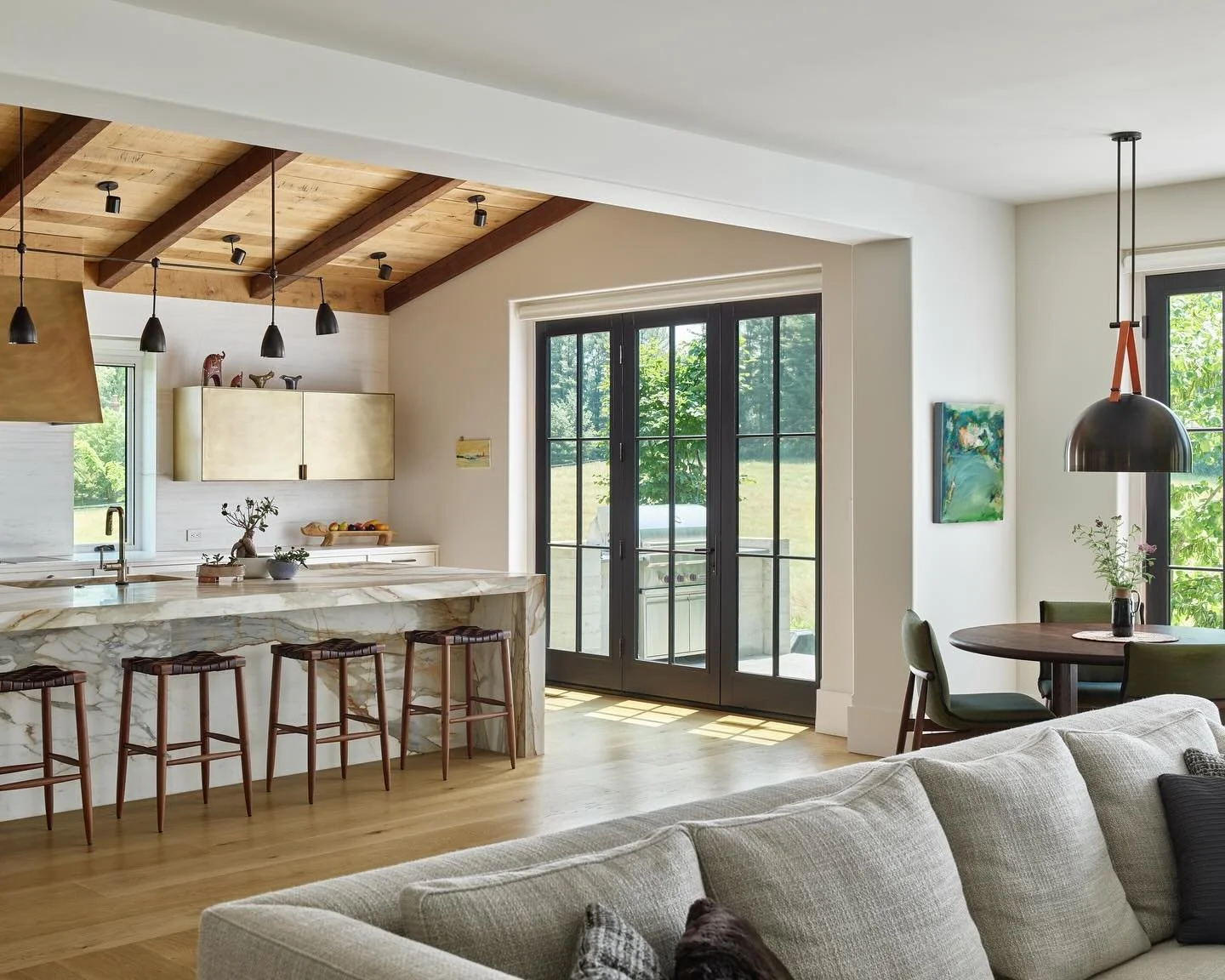 In the &ldquo;Blackbird&rdquo; project&rsquo;s kitchen and family room, polished brass meets rustic wood ceiling, creating a balanced and enduring style. #kitcehn #kitchendesign