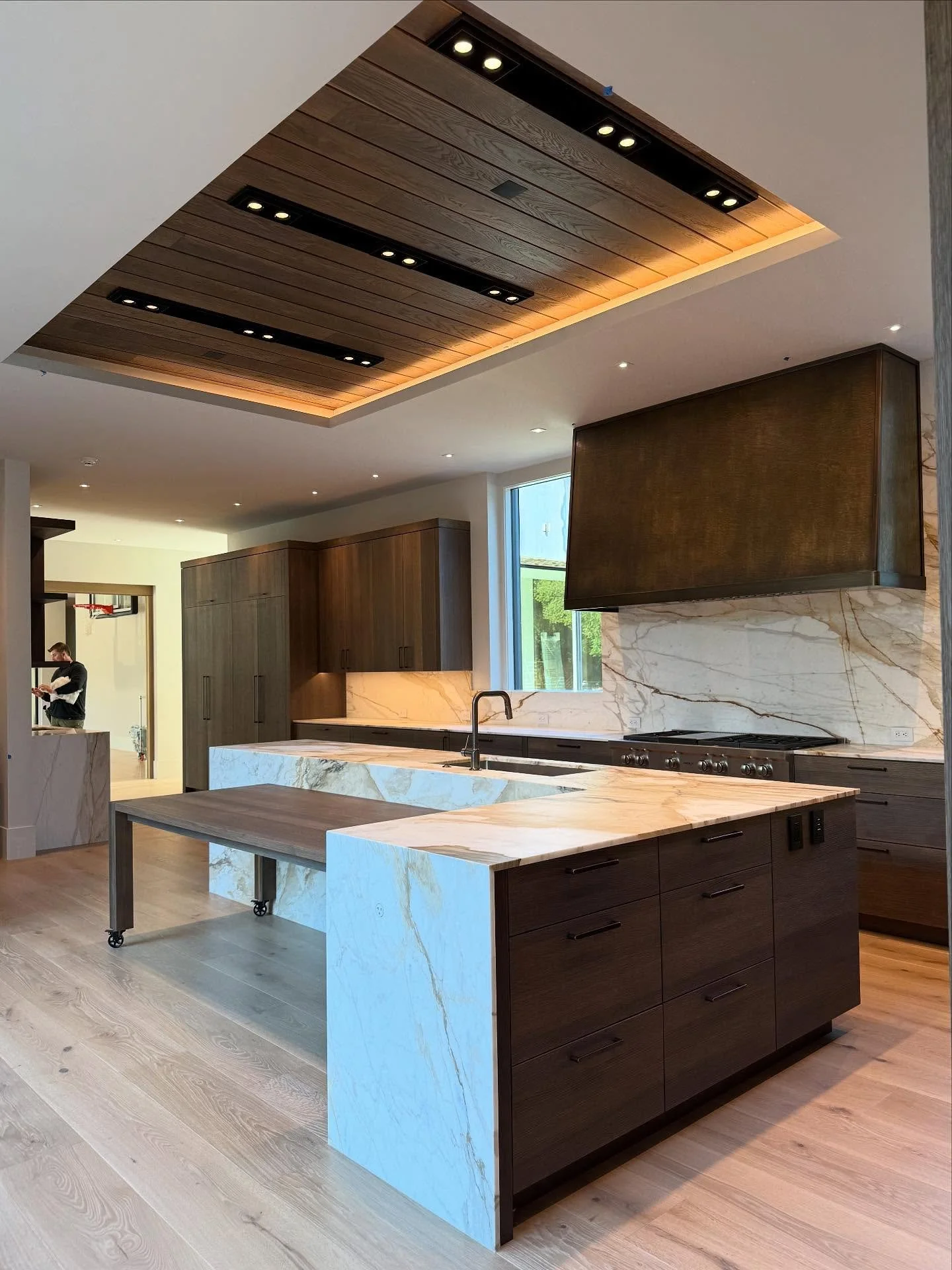 We&rsquo;ve reached a significant milestone in the project: the protective covers have been removed, revealing the completed space. The color palette, featuring smoky woods, highly-grained stone, and patinated brass, is now fully showcased and celebr