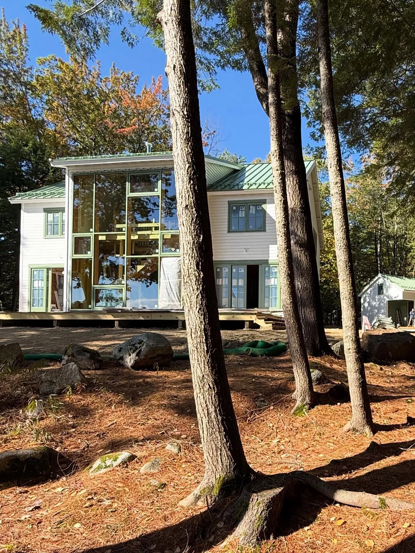 Lakeside cottages project. A serene blend of white ship siding and moss green accents nestled among the trees of this secluded lakefront campground. #cabinstyle #lakecabins #lakelifeisthebestlife #cabinfever