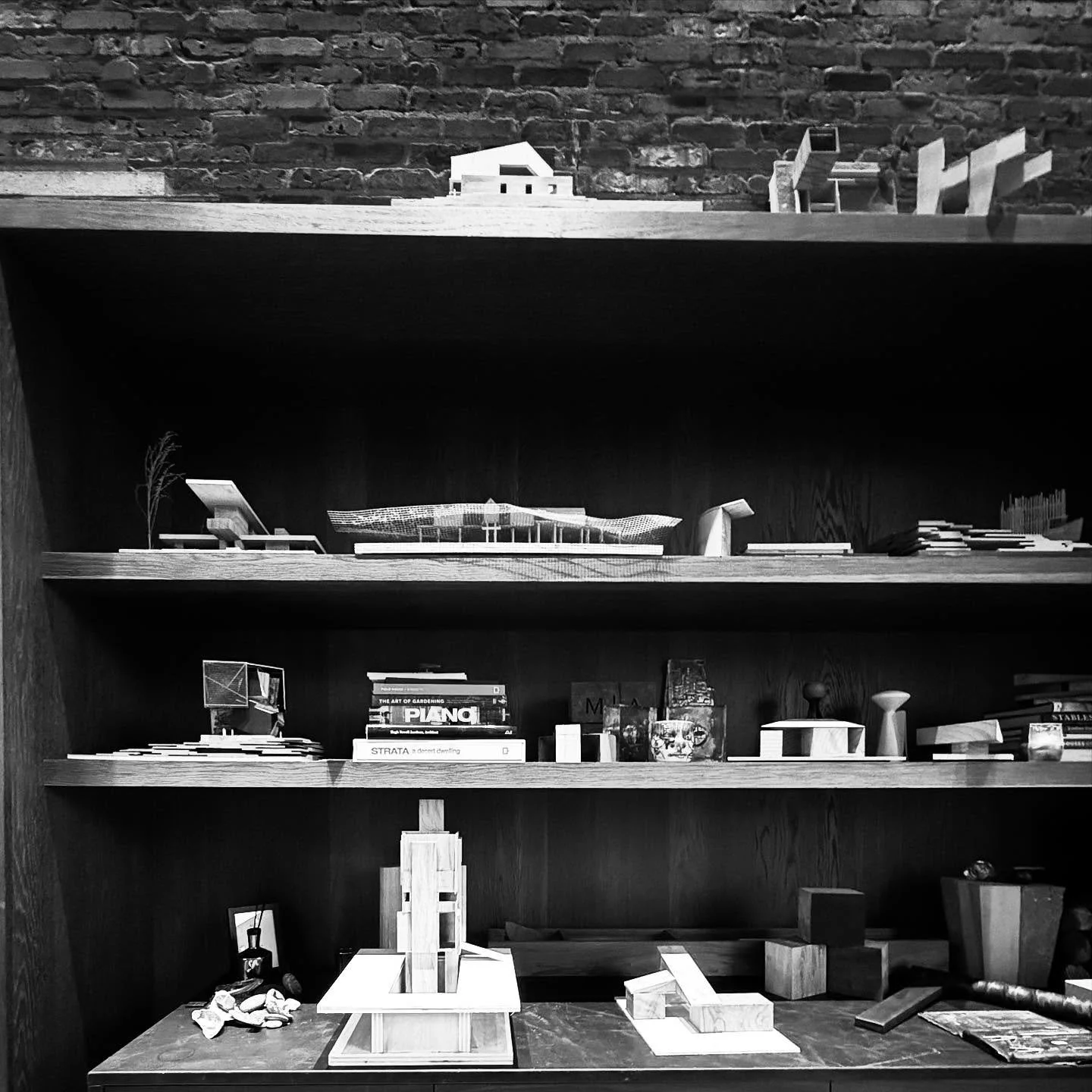 A snapshot of our library wall. It features a diverse collection of books, physical models, and artisan mock-ups that we use for inspiration and design development. We find it to be a valuable resource for our creative process here at MaMo Architects