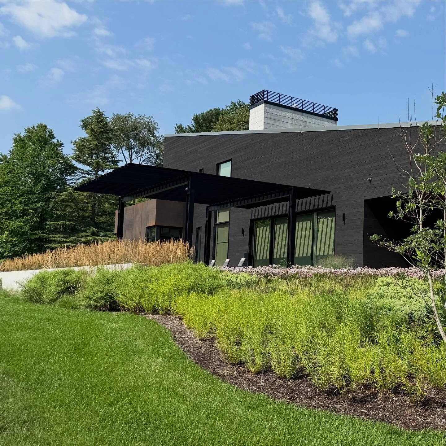 Clean Slate

The weathering steel has almost fully developed its patina, grounding the home in the landscape it inhabits. As the architecture holds its quiet, orthogonal form, the surrounding gardens soften its edges. Over time, the dialogue between 