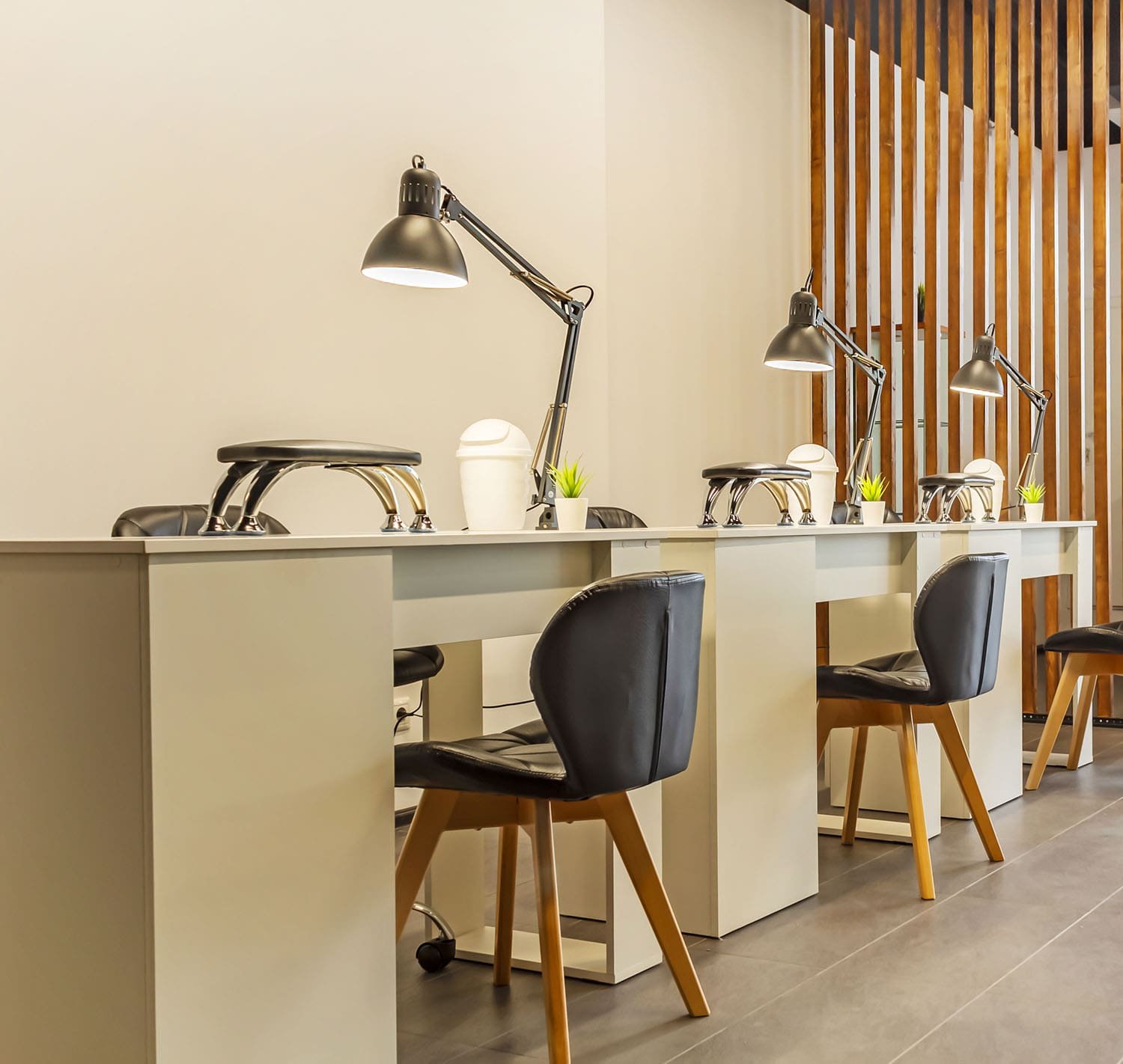 Manicure stations with cozy chairs and lamps at a luxury nail salon