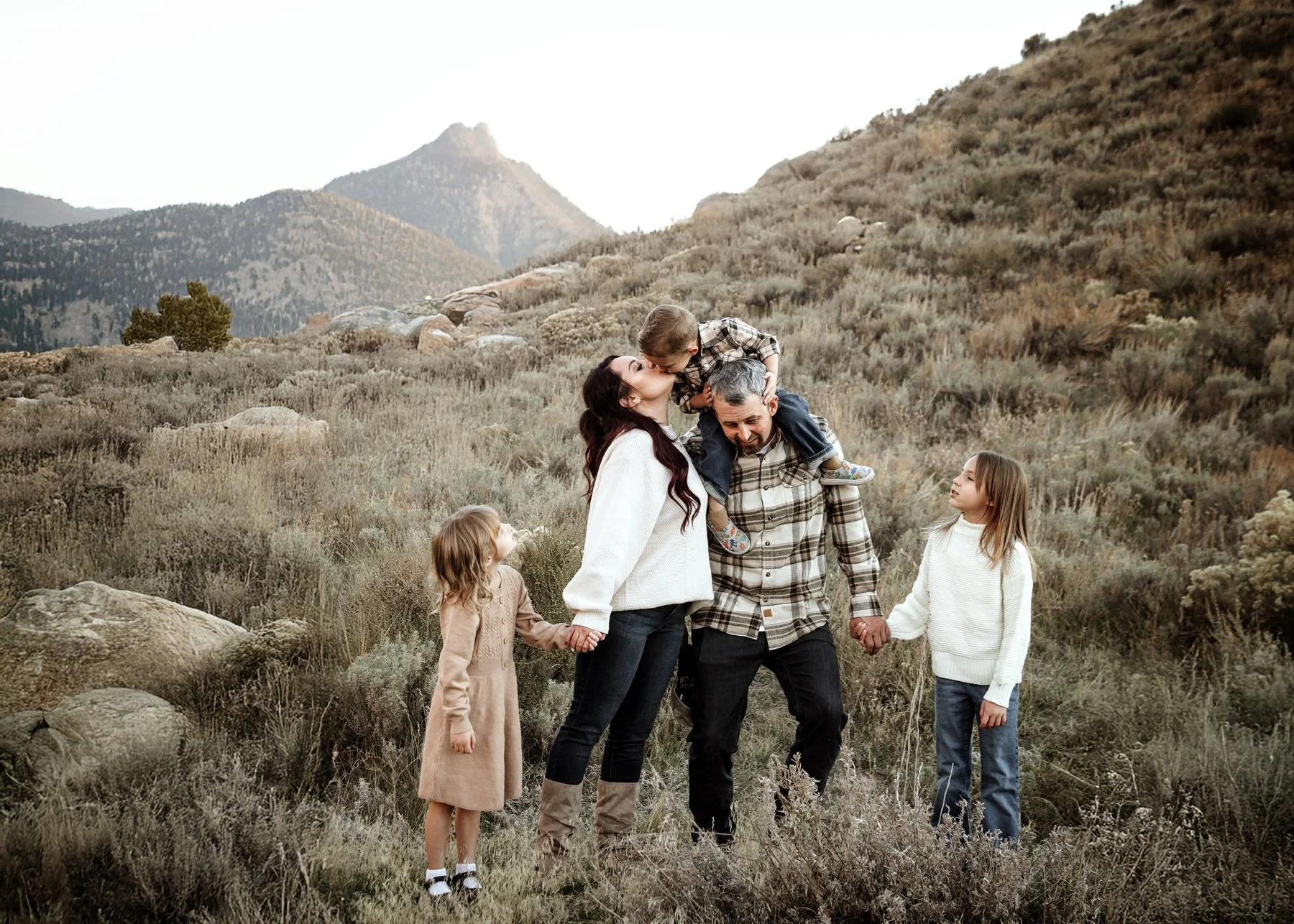 Family walking hand in hand through scenic outdoor setting