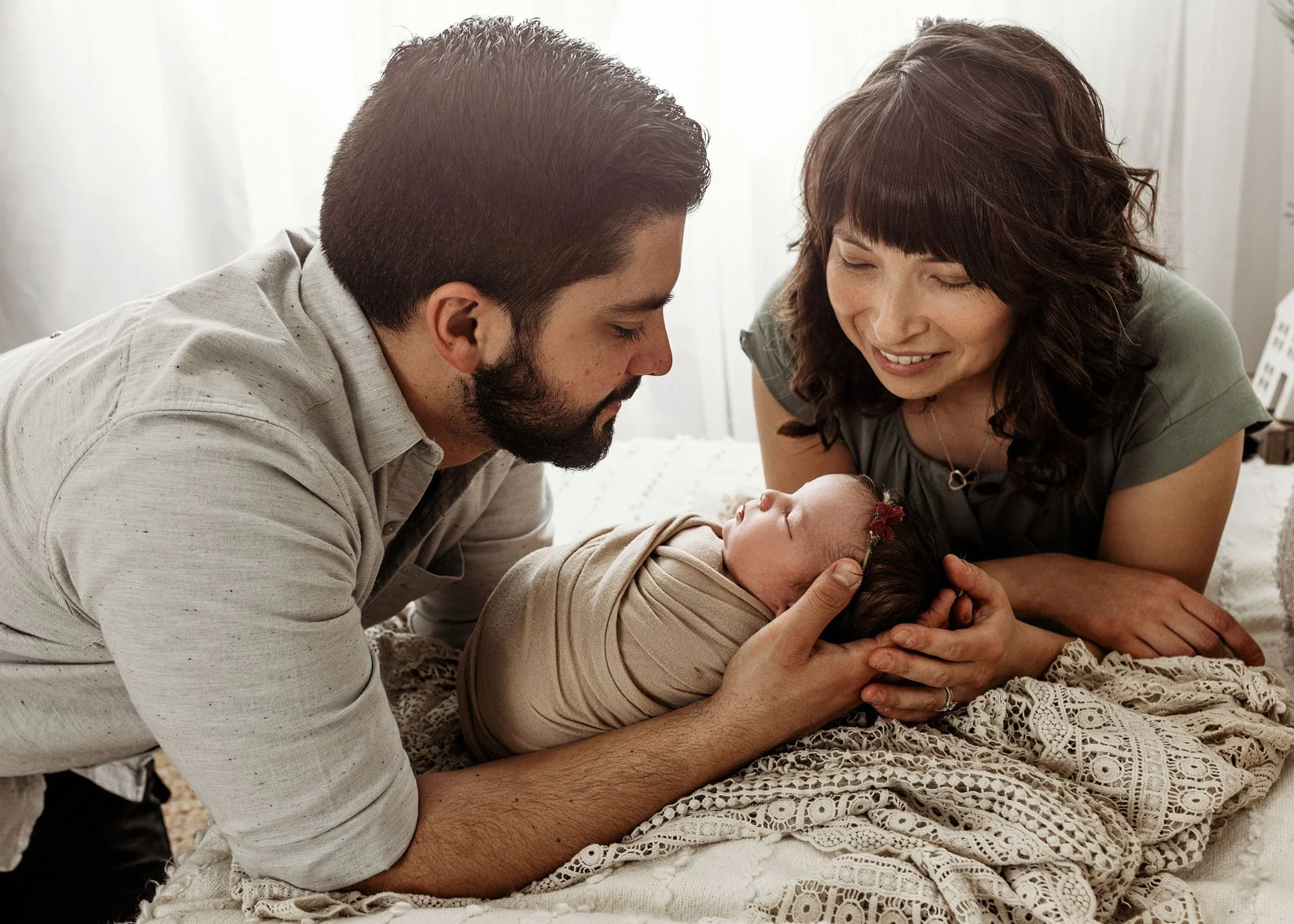 Parents holding newborn together during Idaho Falls newborn photography session