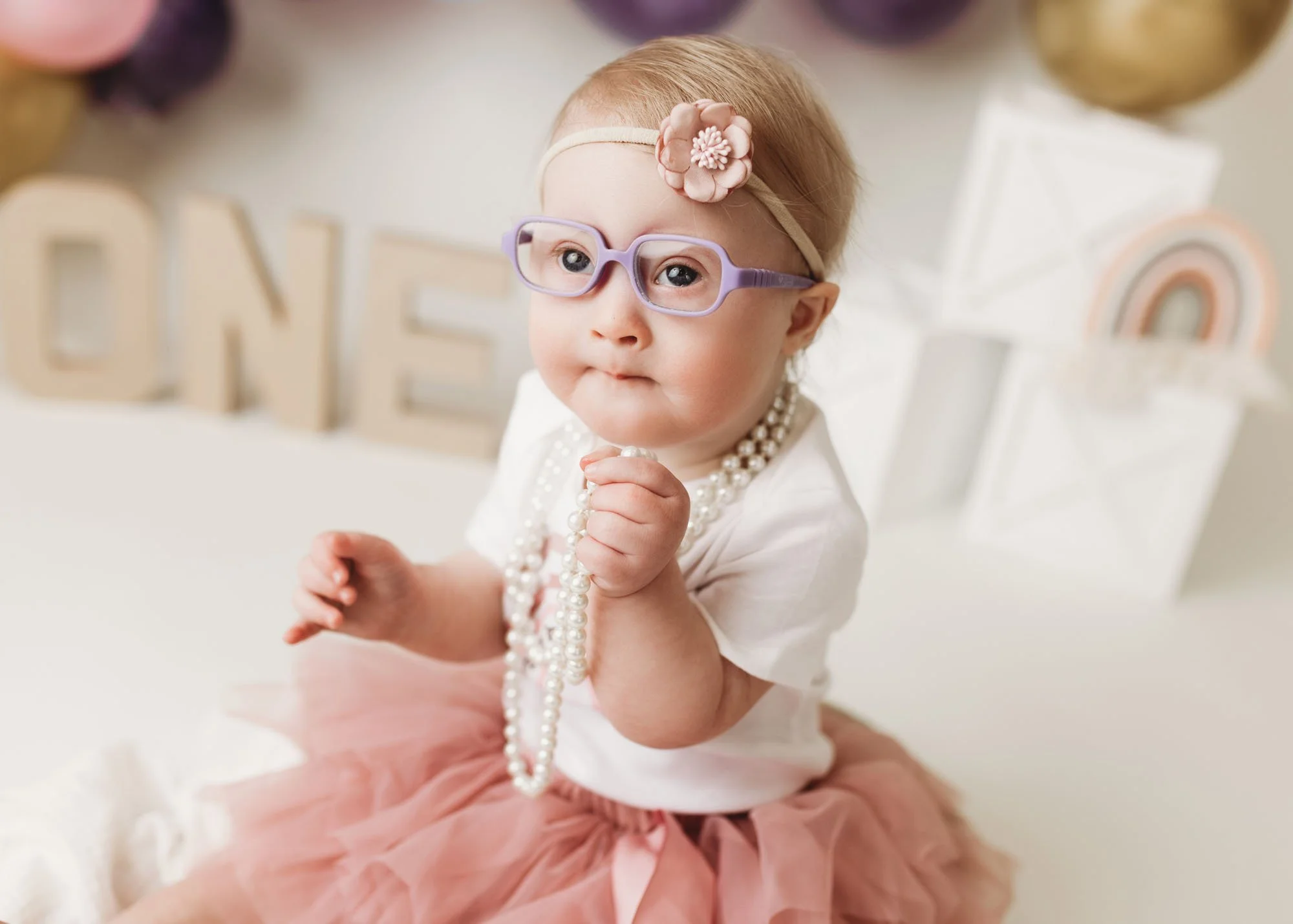 Baby looking up during indoor milestone photography session