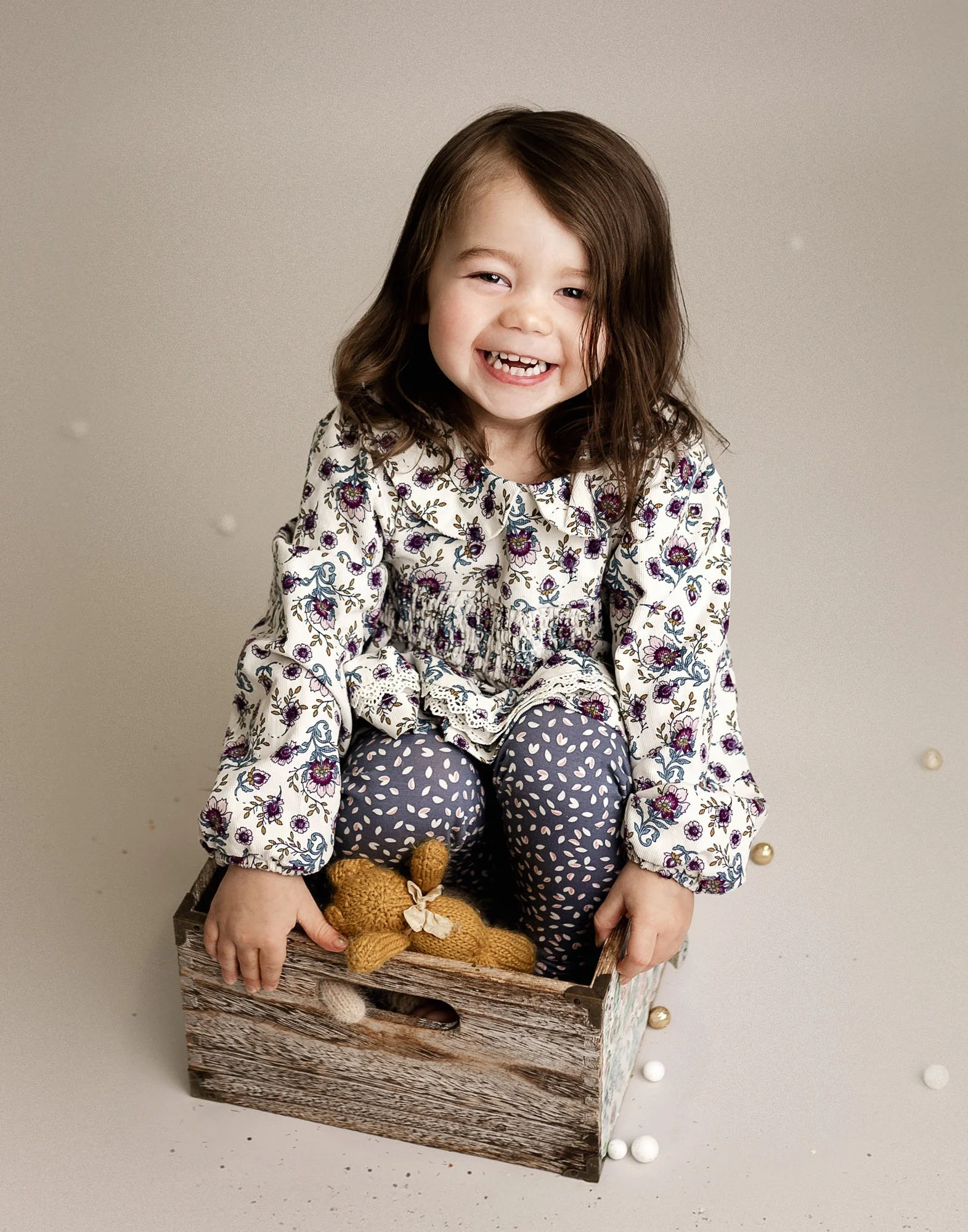 Studio milestone session with baby in rustic bowl