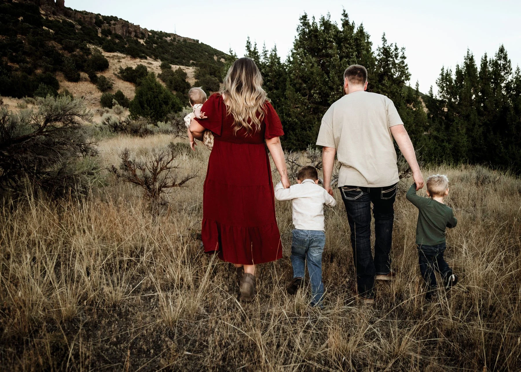 Family walking together while kids play in foreground