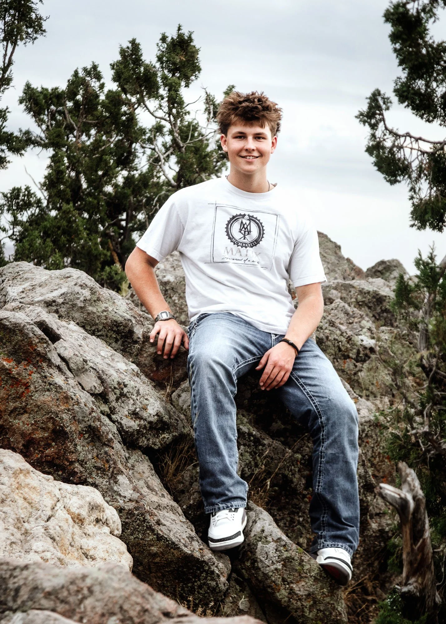  senior boys  posing on mountain  rock and sagebrush