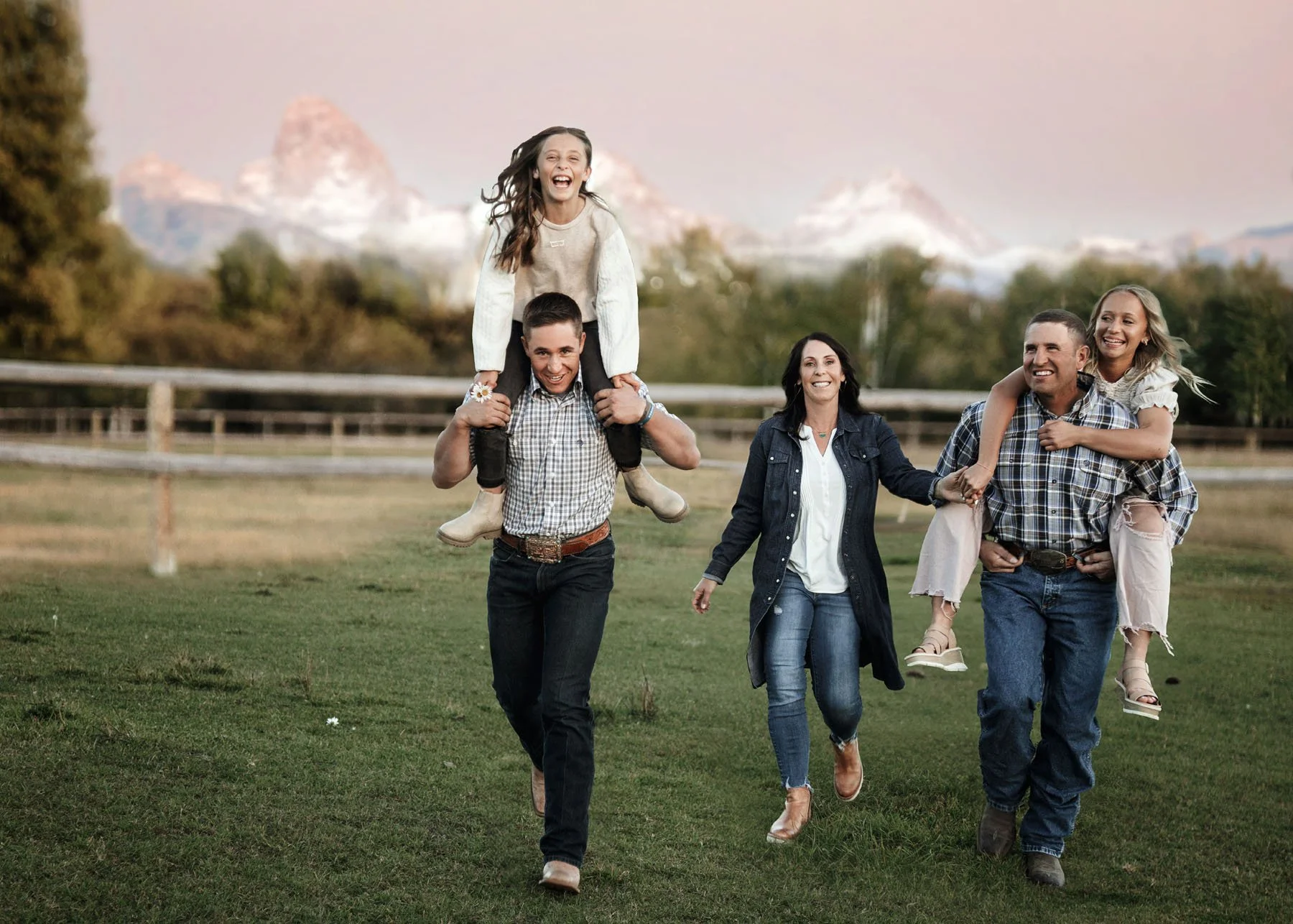 Parents talking and laughing with children in outdoor session