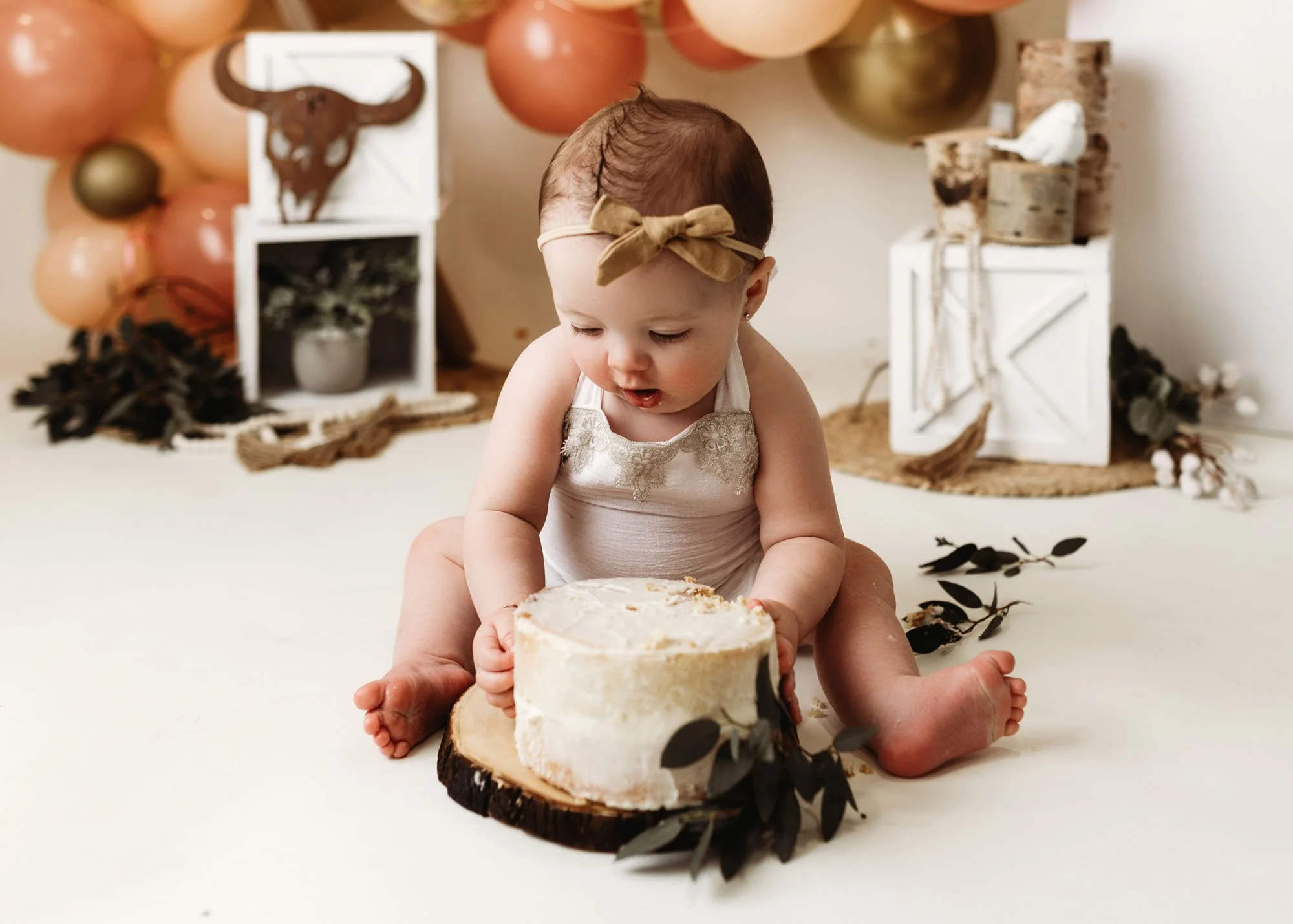 One year old celebrating first birthday with camping cake