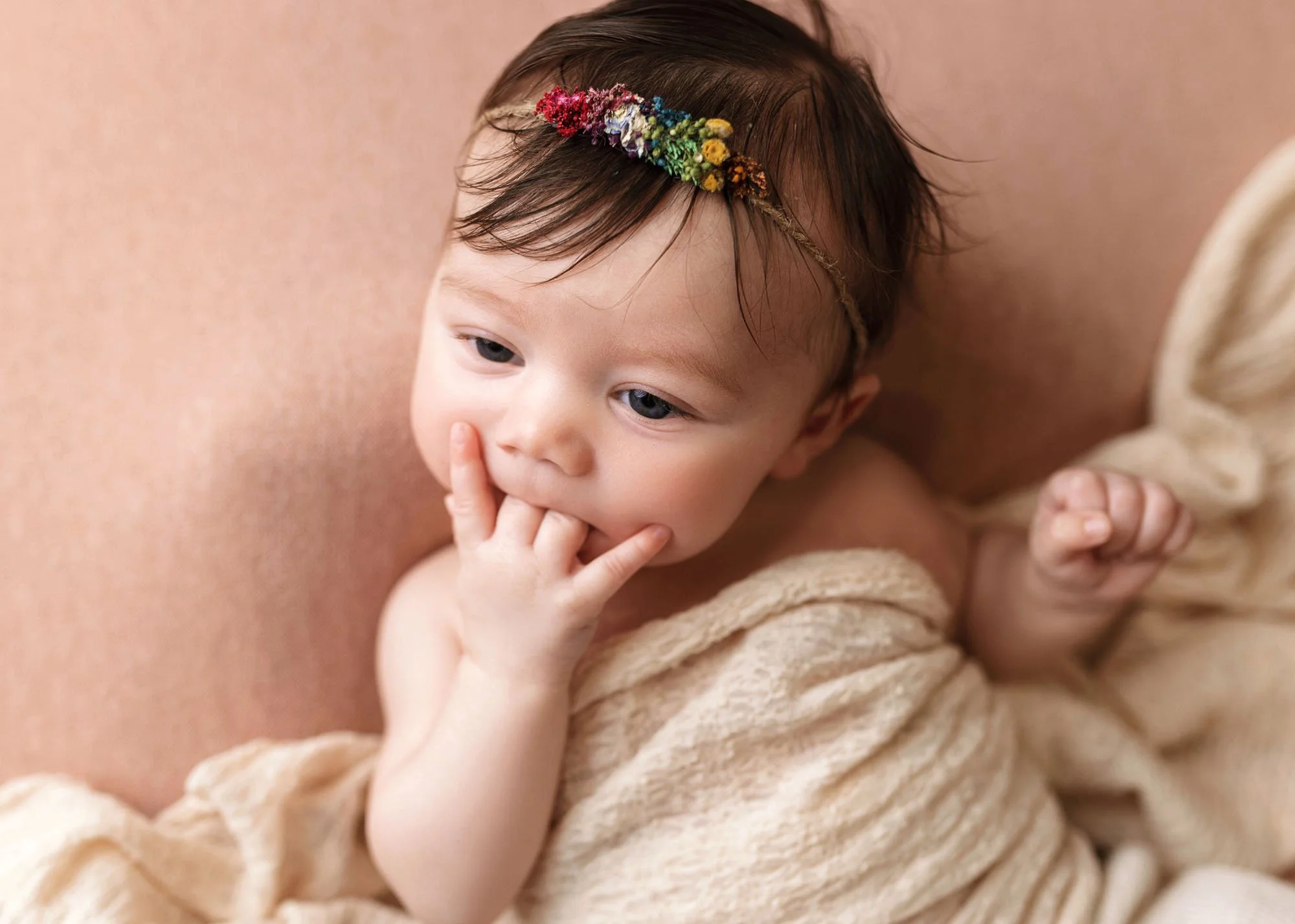 Milestone photo of baby lying on tummy smiling