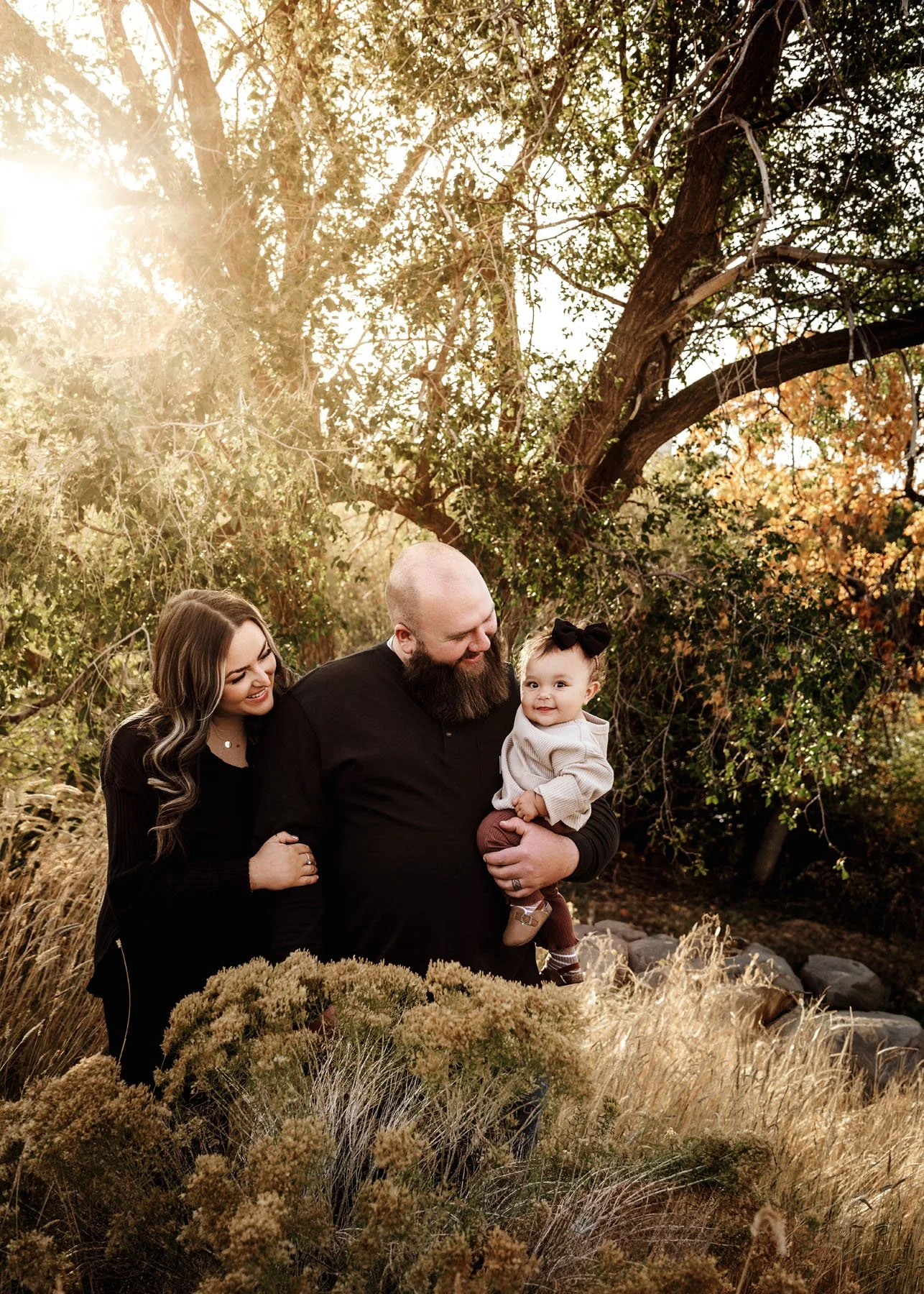 Family casually standing together outdoors in relaxed poses