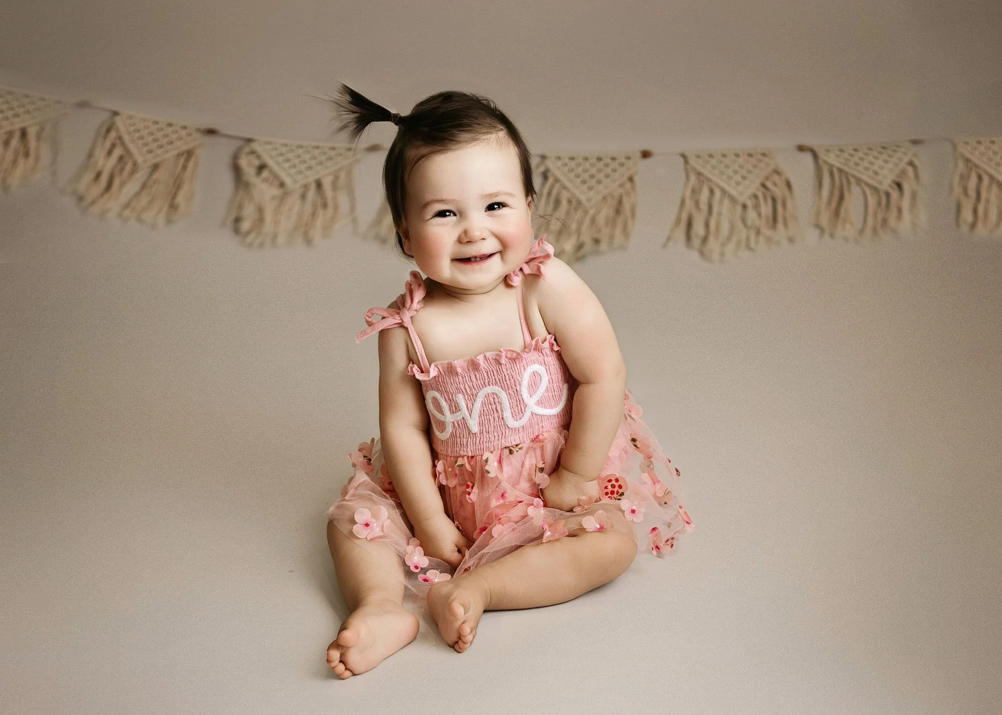 Happy baby smiling during milestone photography session