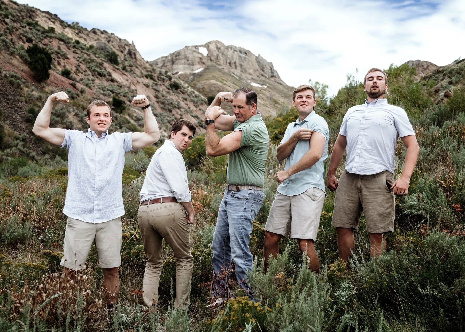 Children exploring while parents pose in mountain landscape