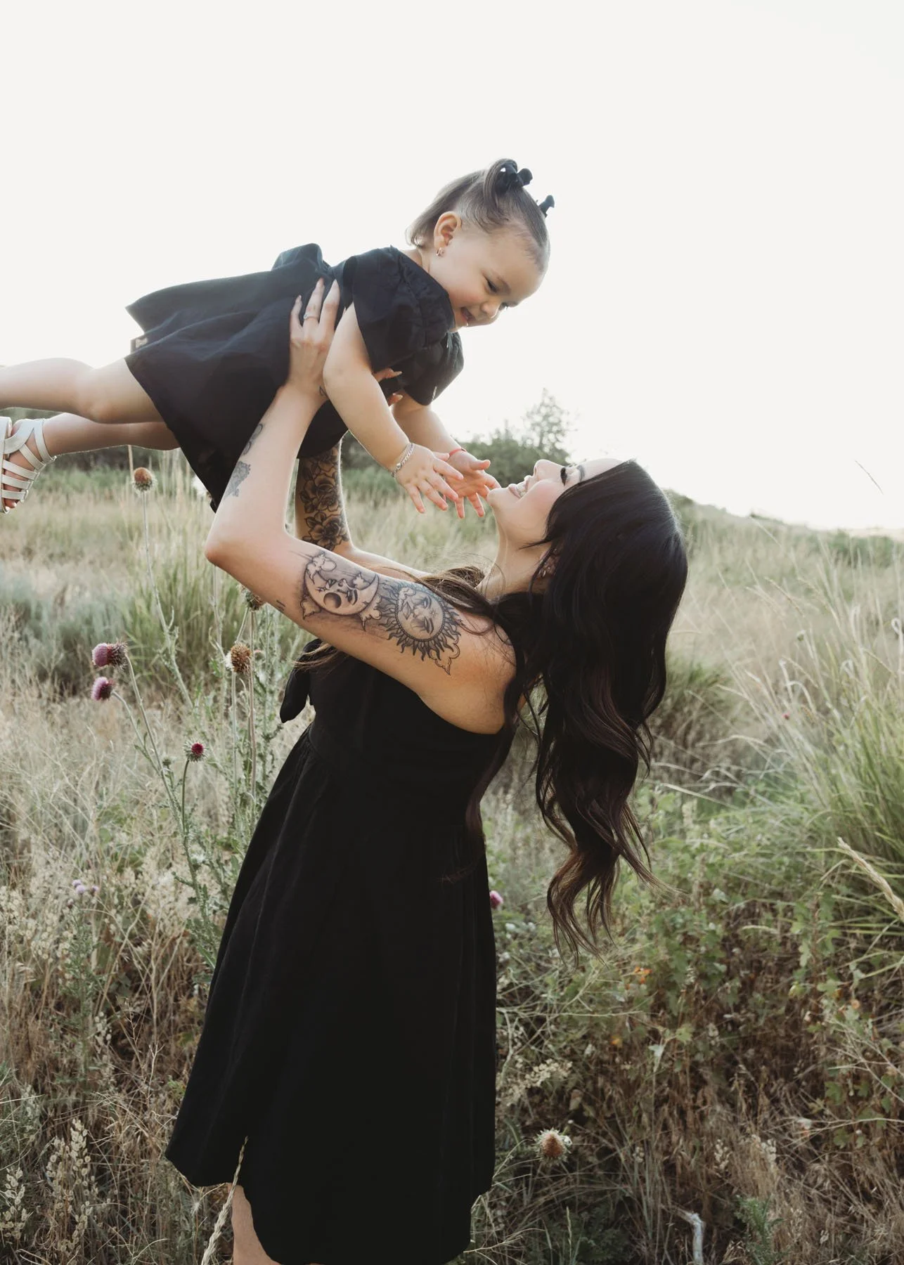 Kids being lifted into the air by parents during family session