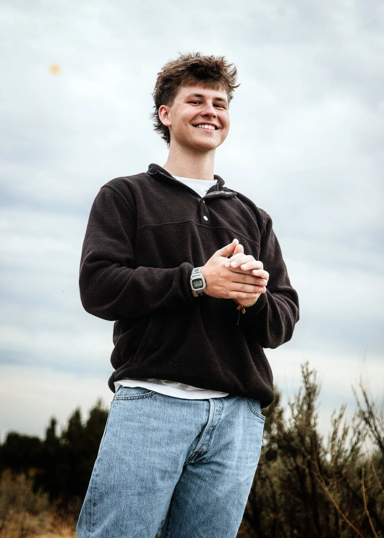  senior boys  posing with sky behind

