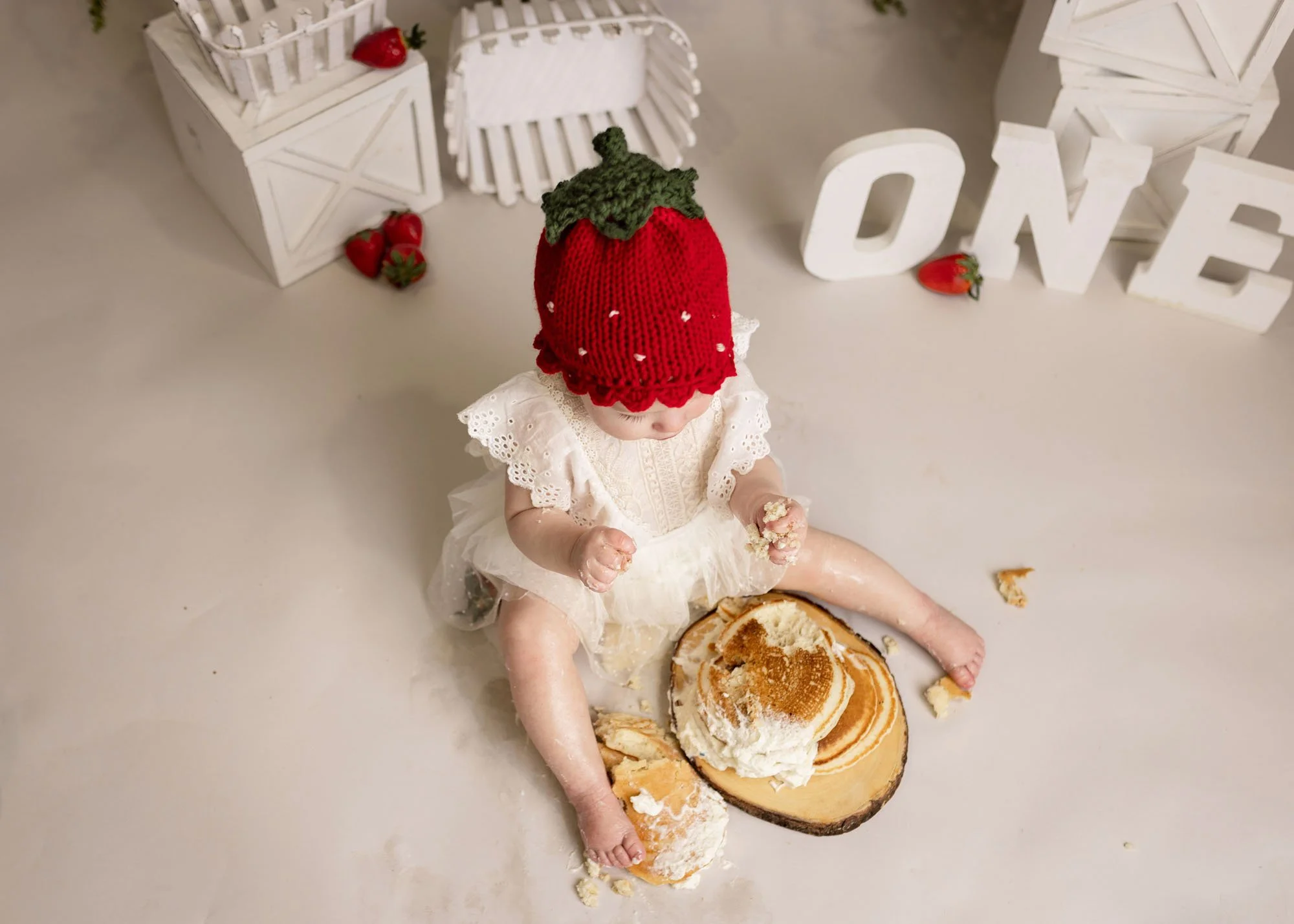 One year old enjoying strawberry pancake smash session