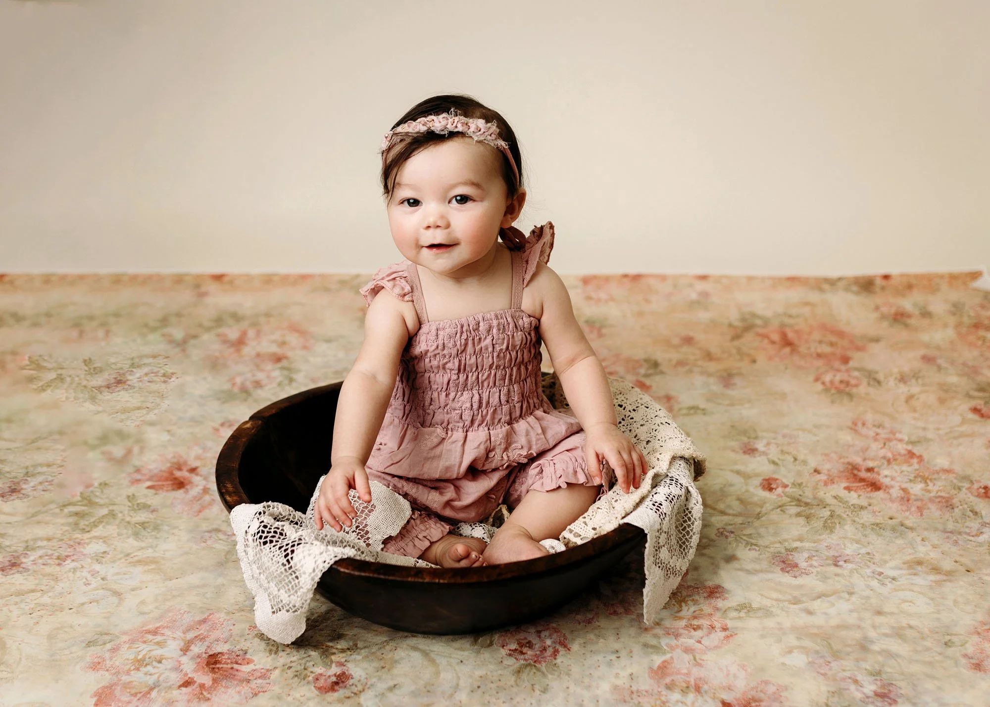 Baby sitting in rustic bowl in cozy studio session