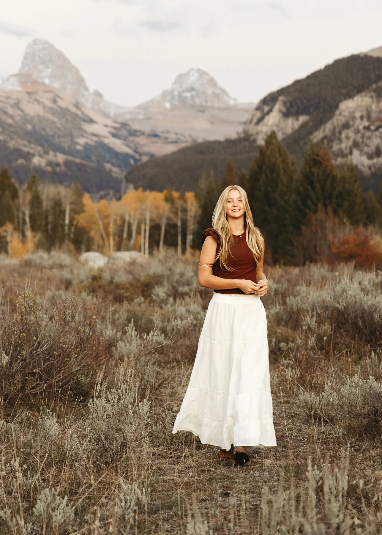 Senior girl standing in front of Teton Mountains for portrait