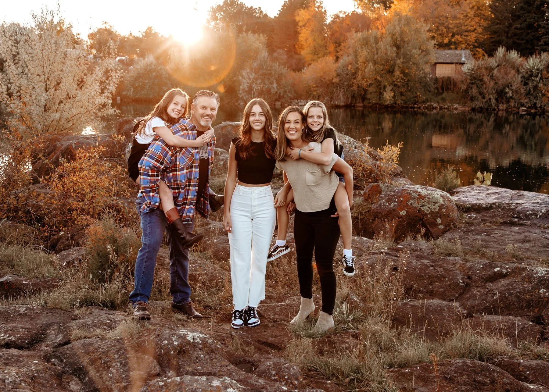 Family portrait session with sagebrush, rocks, and river backdrop