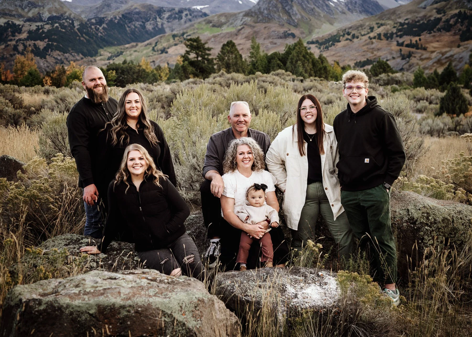 Parents and children casually posing in mountain landscape