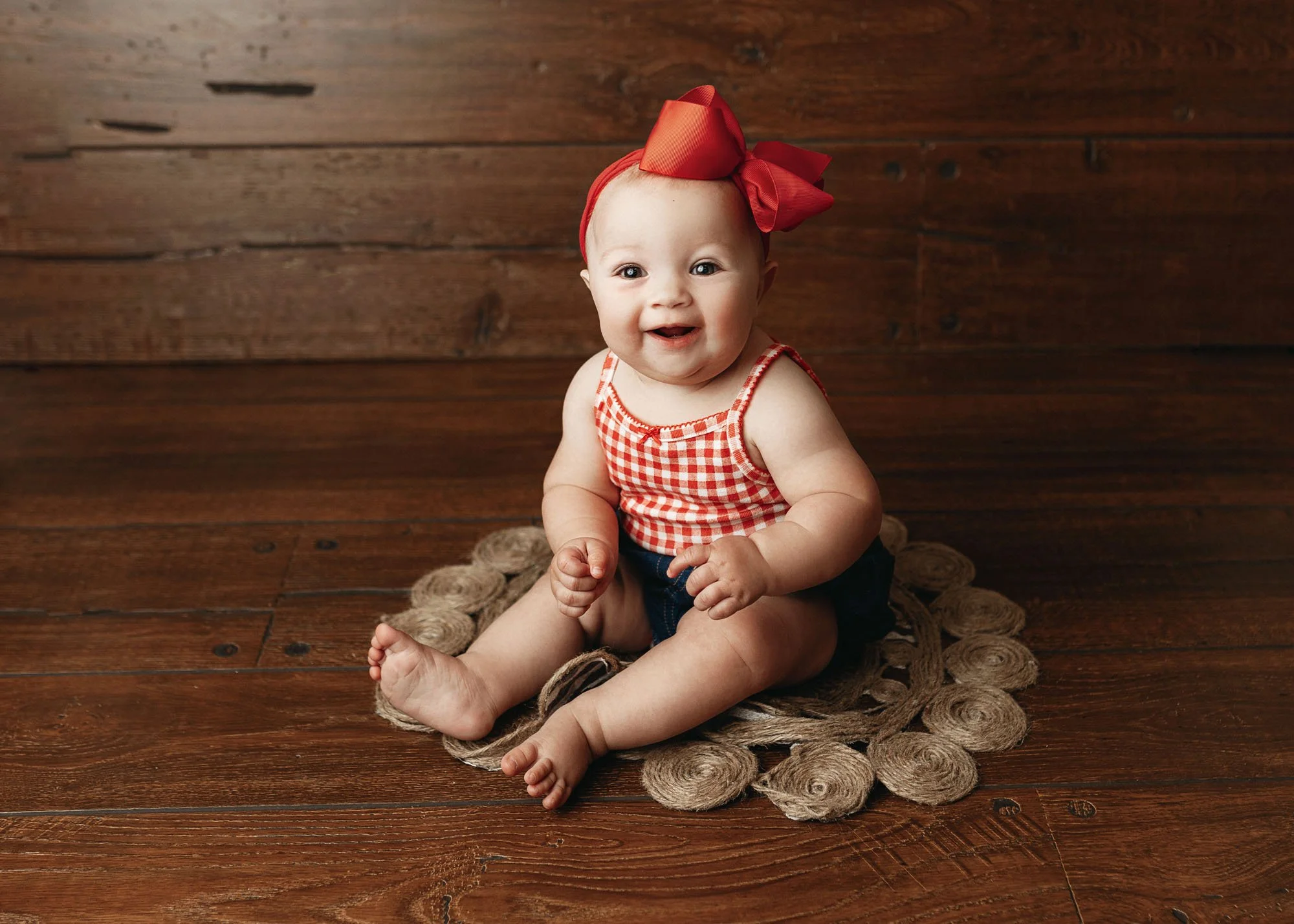 Infant posing naturally and looking at camera in studio