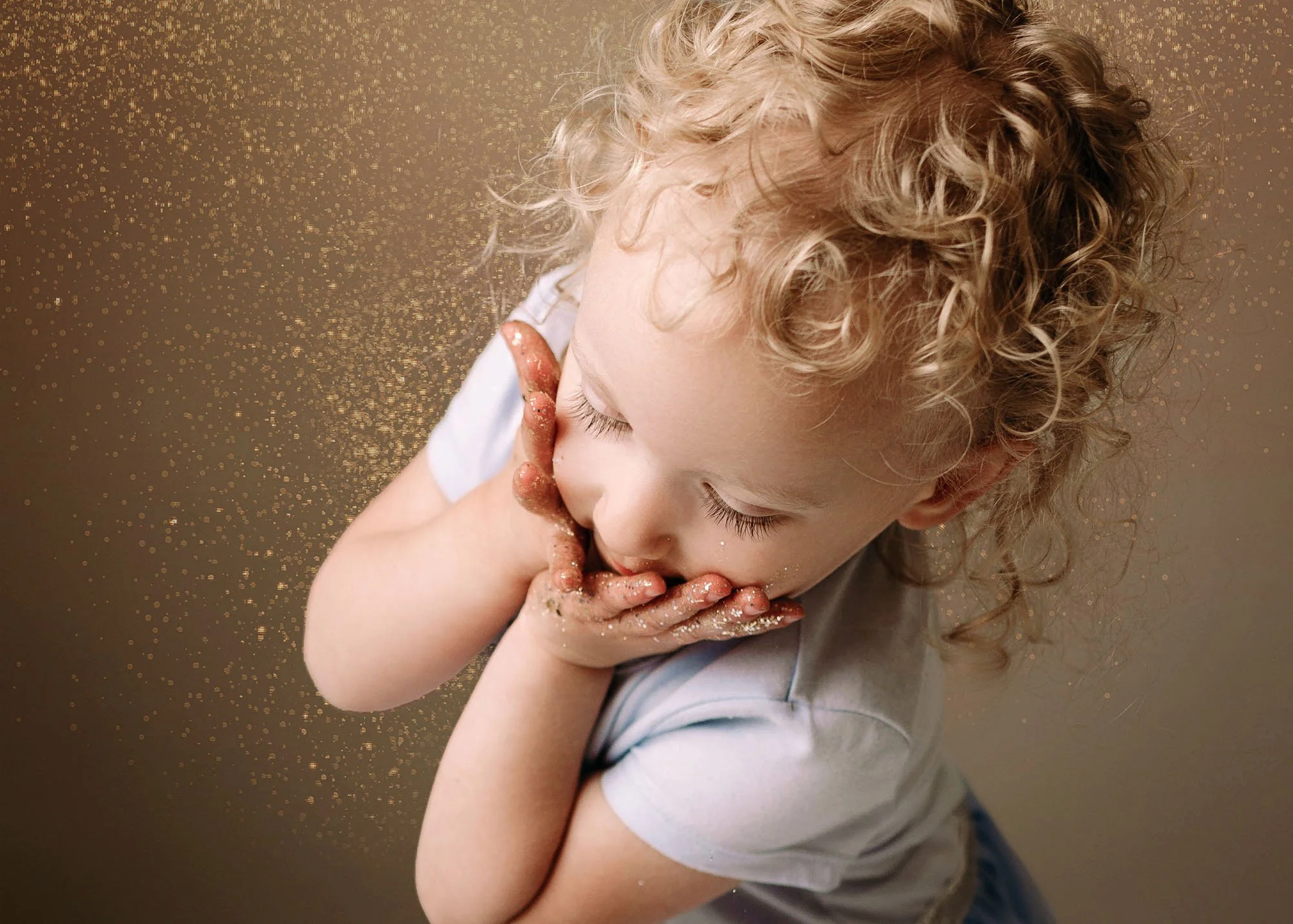 Two-year-old covered in glitter during fun milestone session