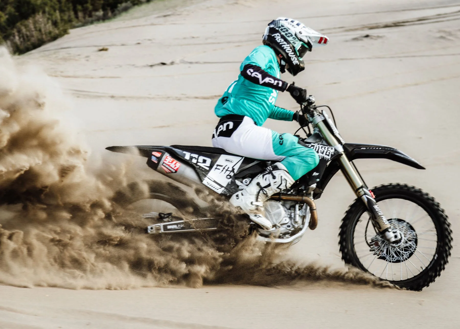 Teen boy riding motorbike in mountains for senior session