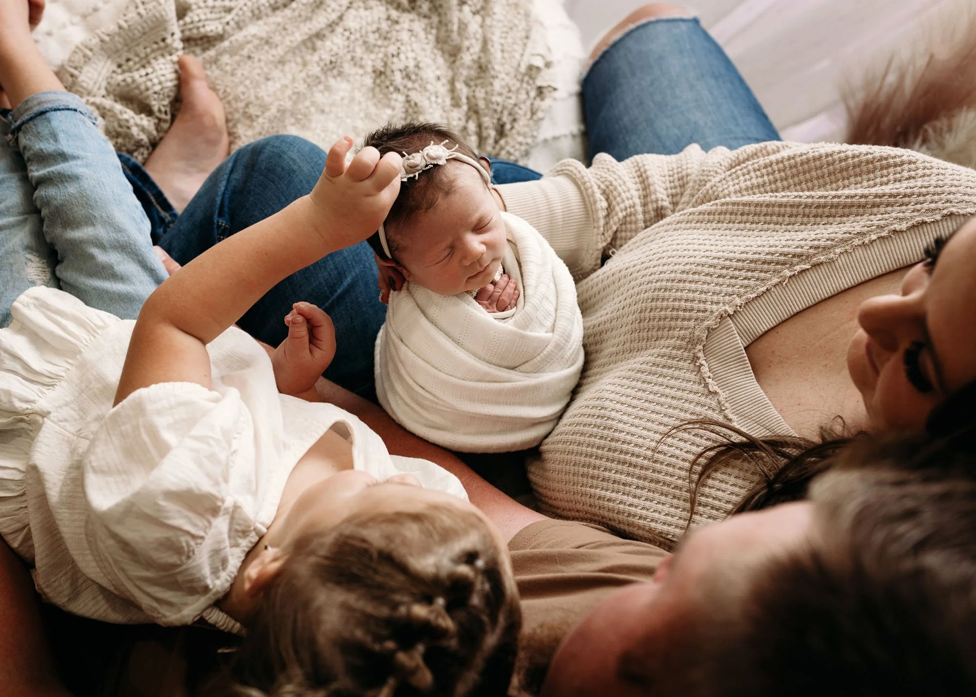 Birdseye view of baby being held by family