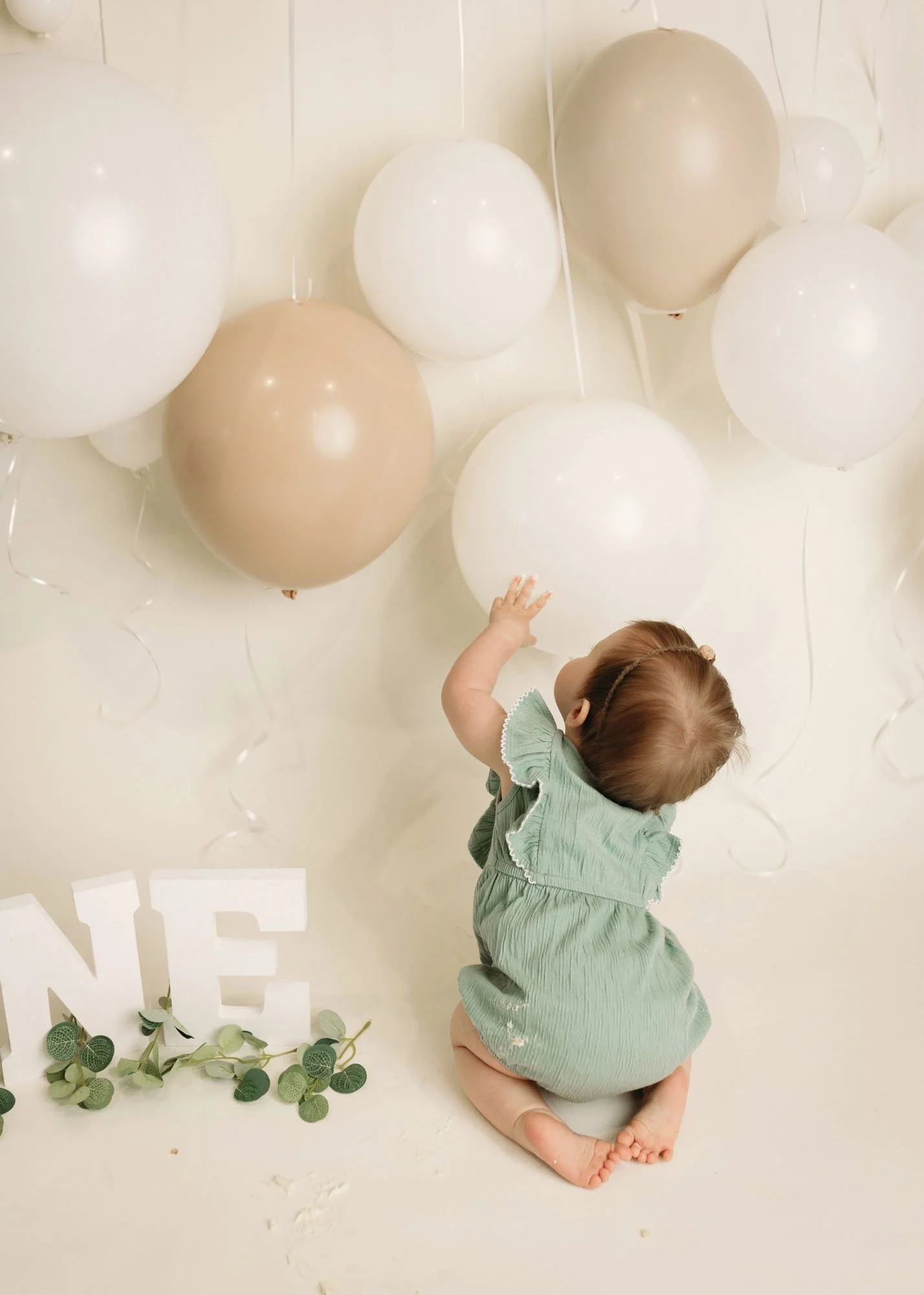 Studio cake smash with neutral backdrop and toddler fun