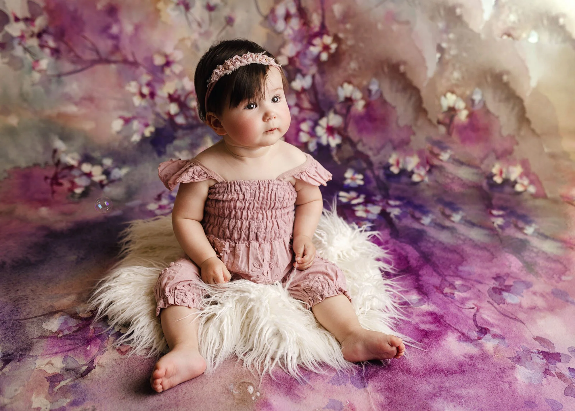 Milestone photo of baby looking up with happy expression