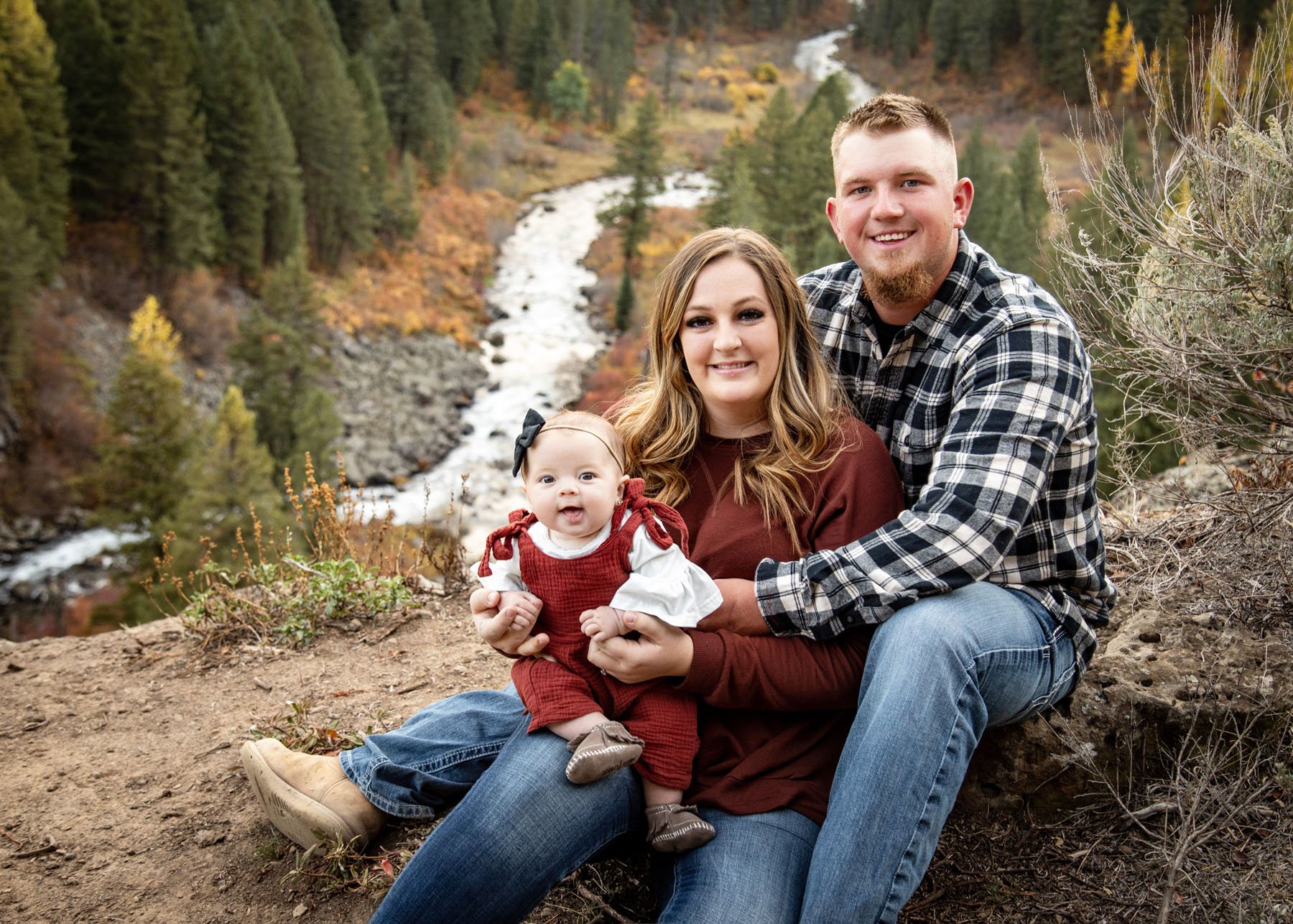 Outdoor family portrait session with mountains and river