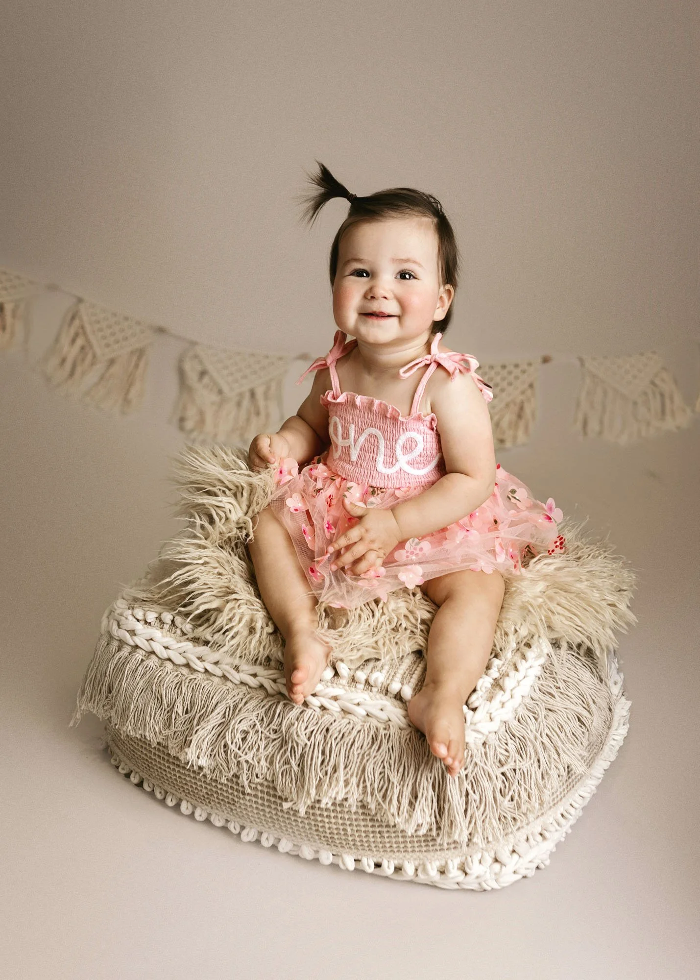 Infant in basket smiling during milestone photography