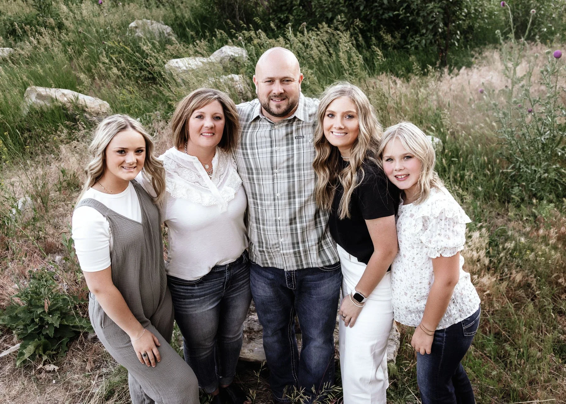 Kids playing while parents smile in rocky mountain setting