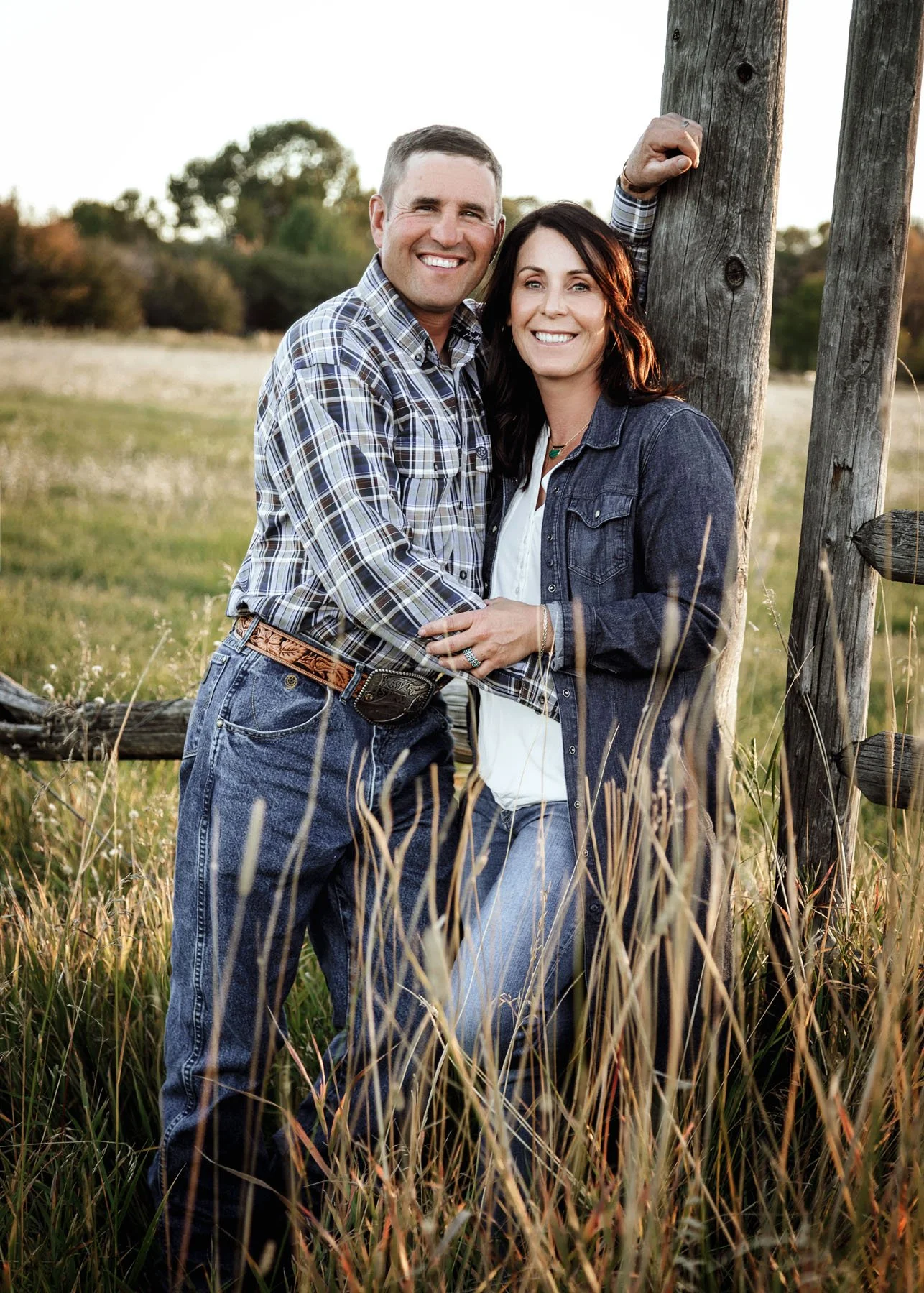 Family session with mountains, trees, and flowing river backdrop