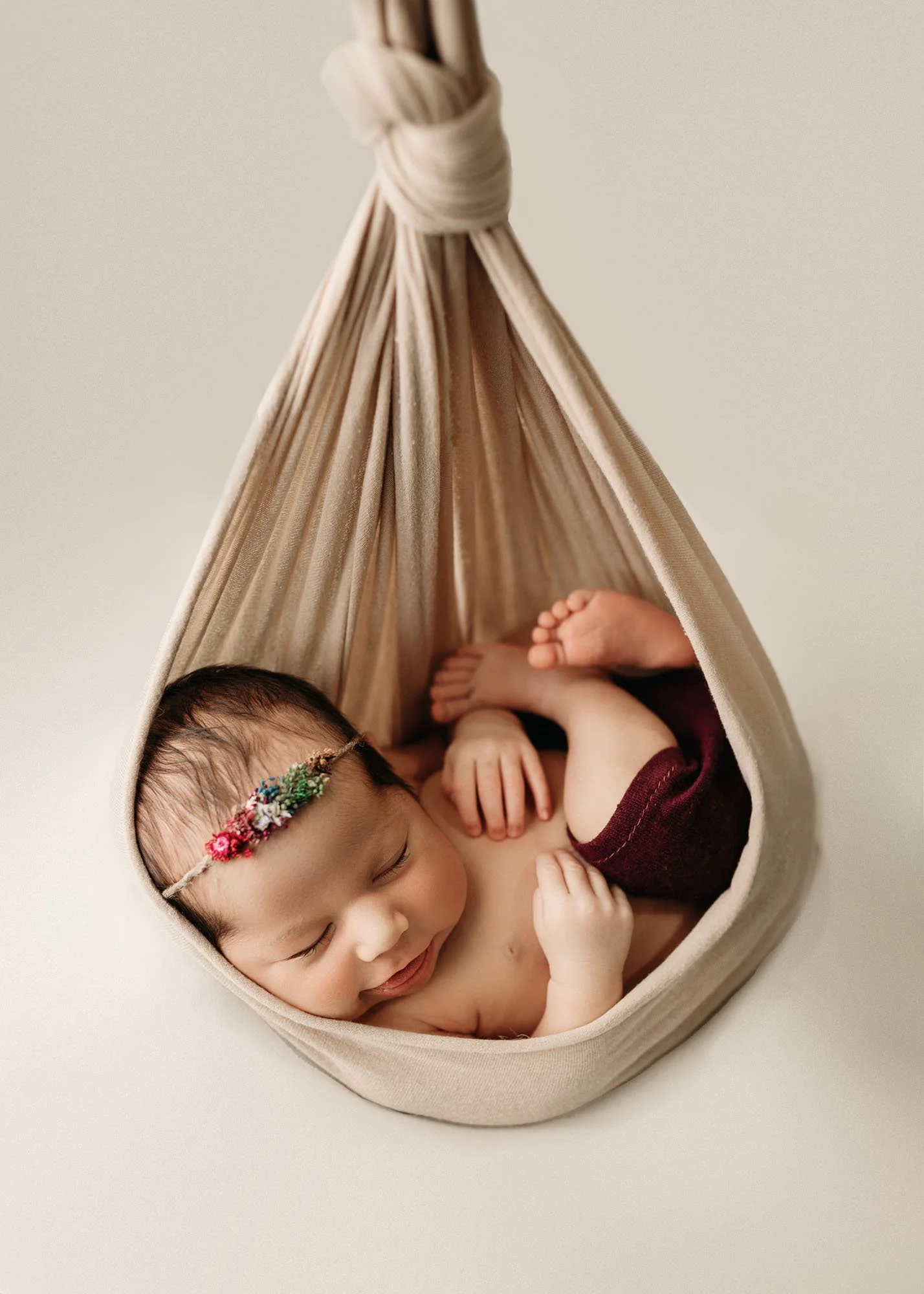 Newborn in styled hanging basket inspired bum up pose