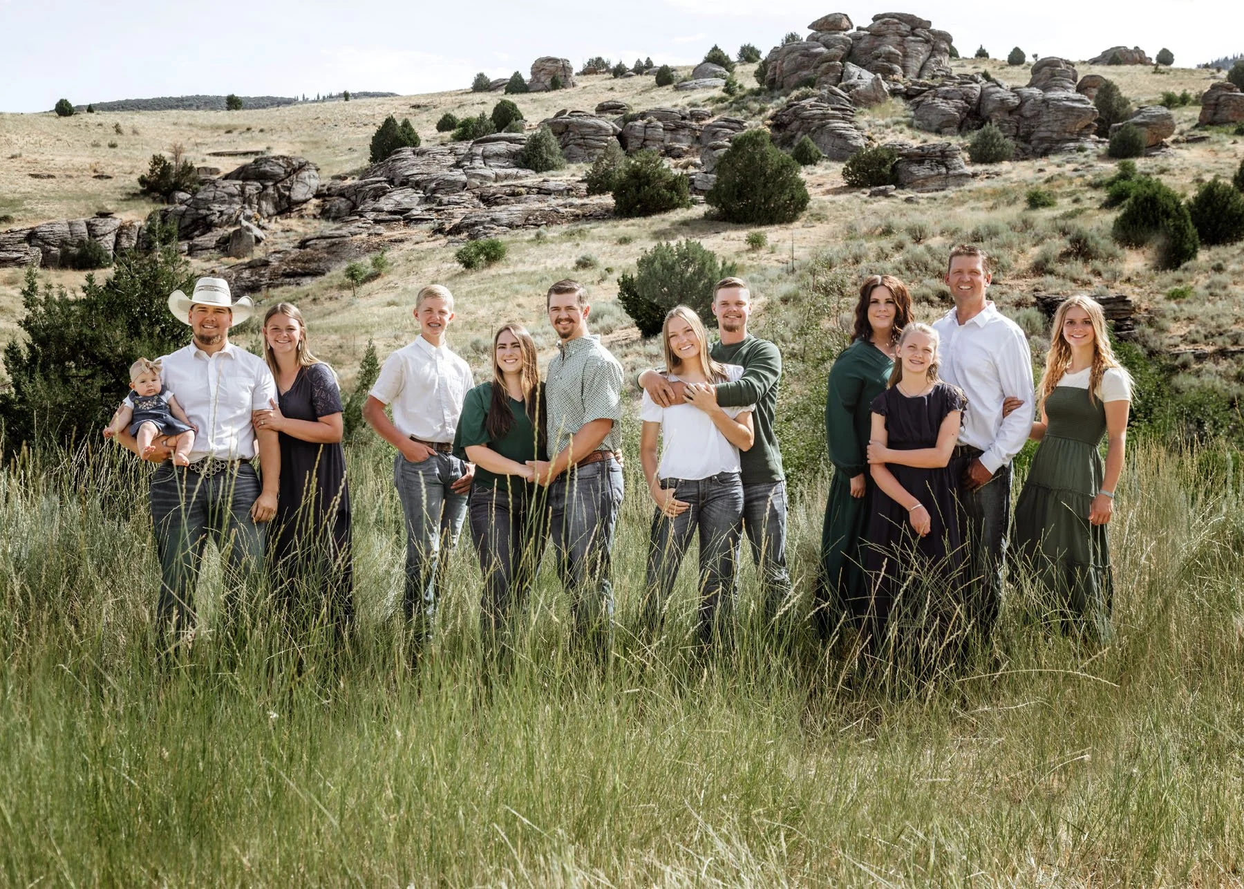Children playing near bold rocks with mountains behind