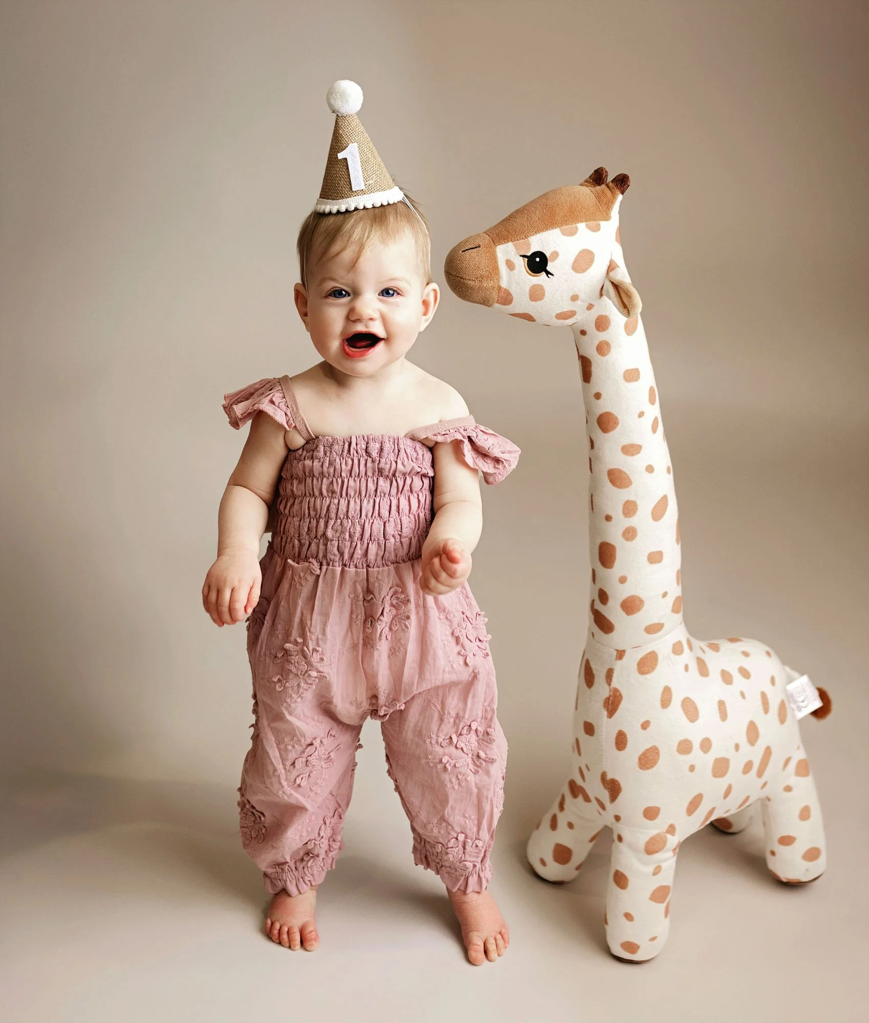 Two-year-old covered in glitter during fun milestone session