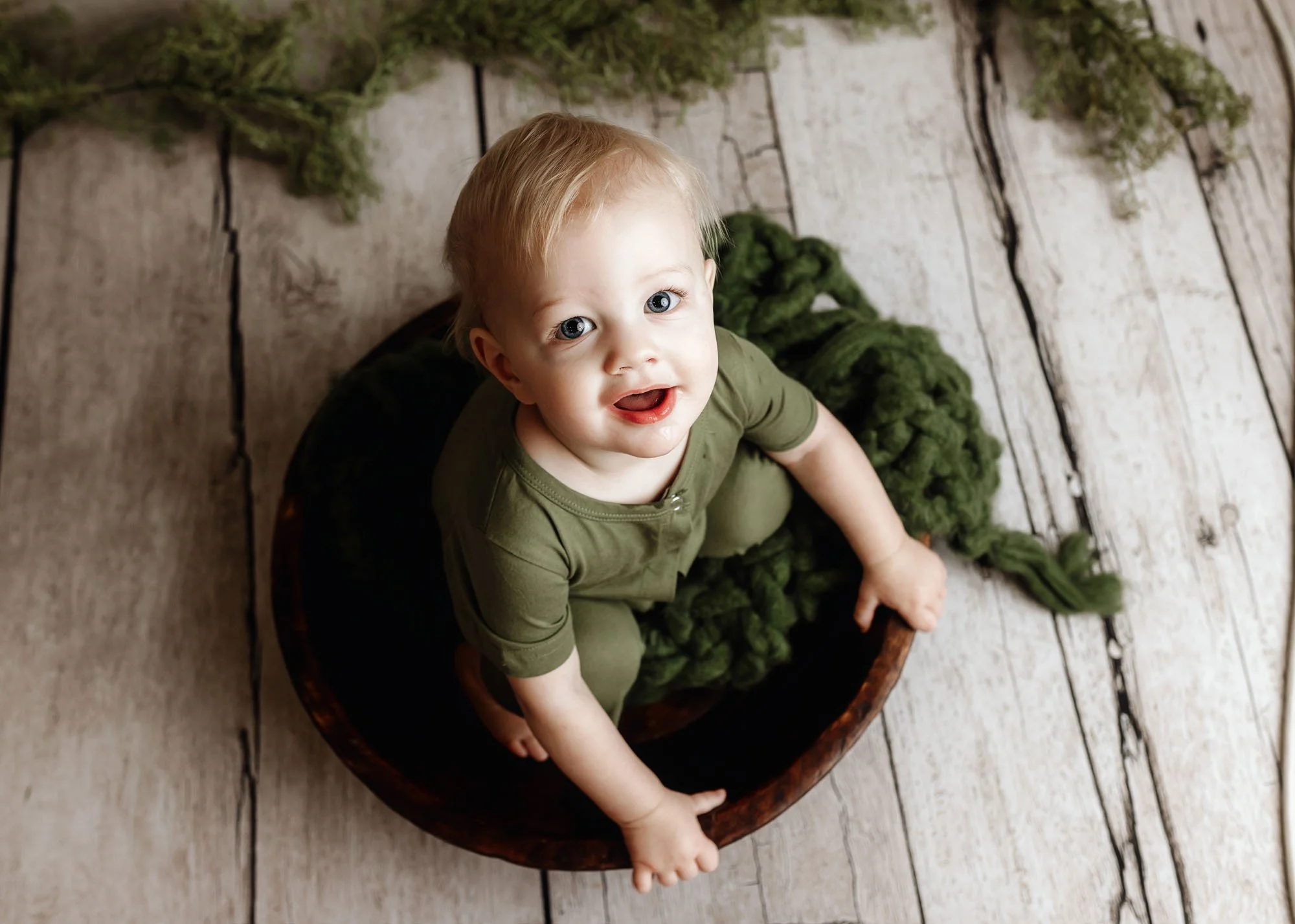 Baby exploring and looking at camera for milestone session