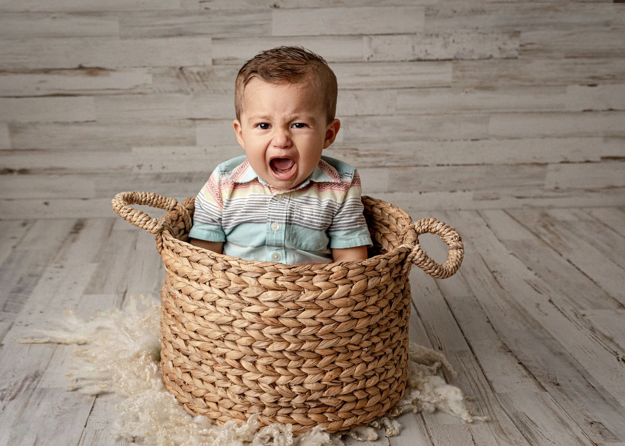 Studio  session with baby in basket with cute crying expression