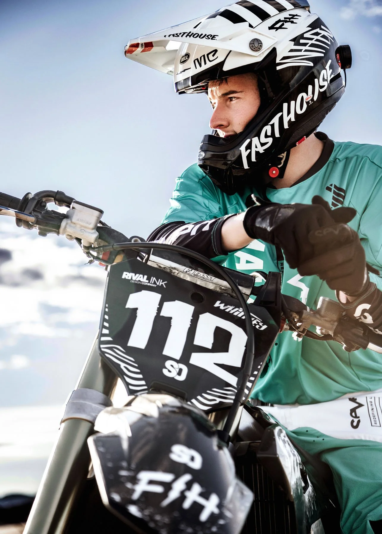 Senior boy on motorbike with rocky mountain backdrop