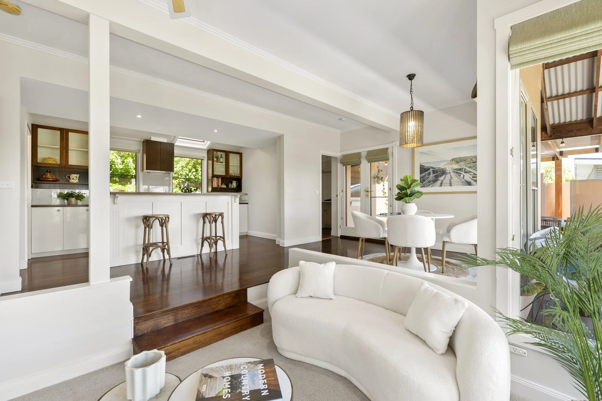 Styled living area featuring rich timber flooring and neutral furnishings – Property Styling Geelong