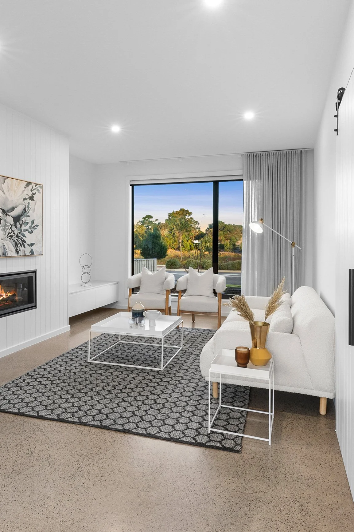 Warm and inviting living room with neutral palette and central fireplace – Geelong property styling