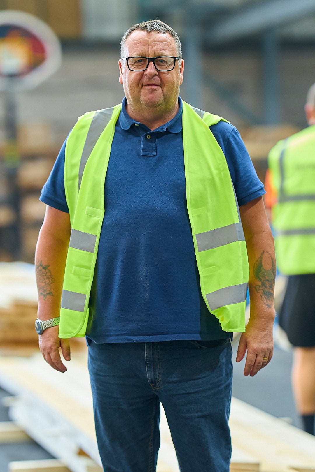 Man in safety vest standing indoors