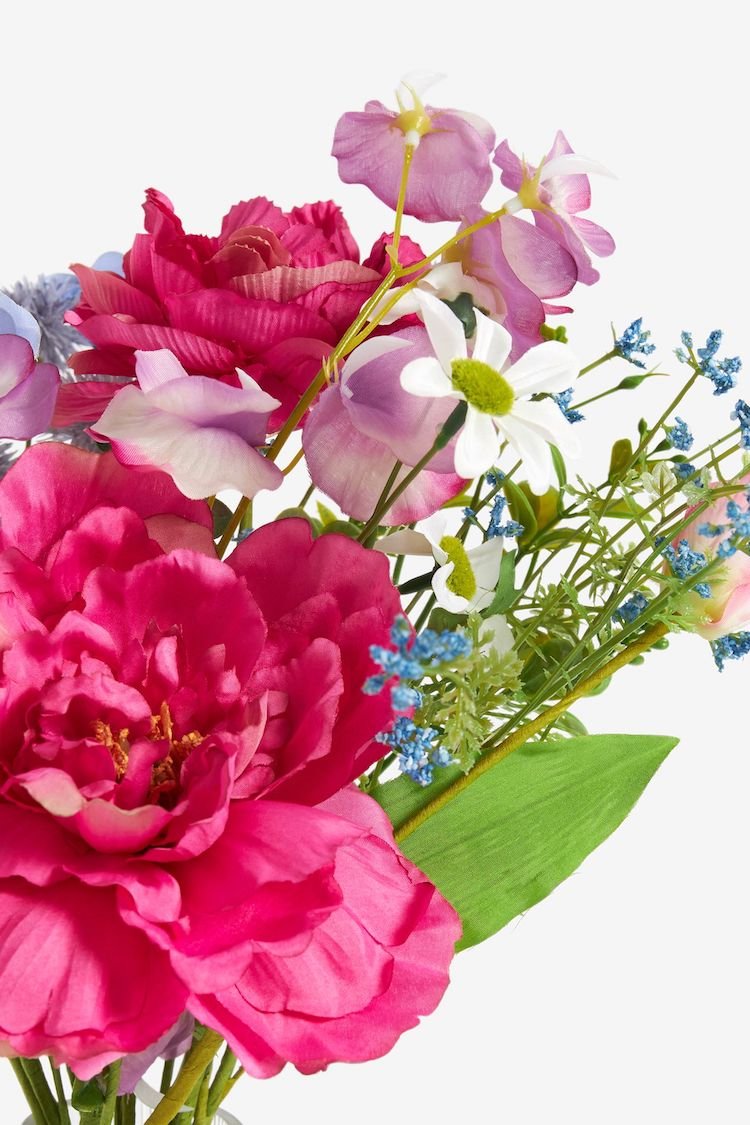 Bouquet of flowers including pink peonies, daisies, and small blue flowers on a green stem.