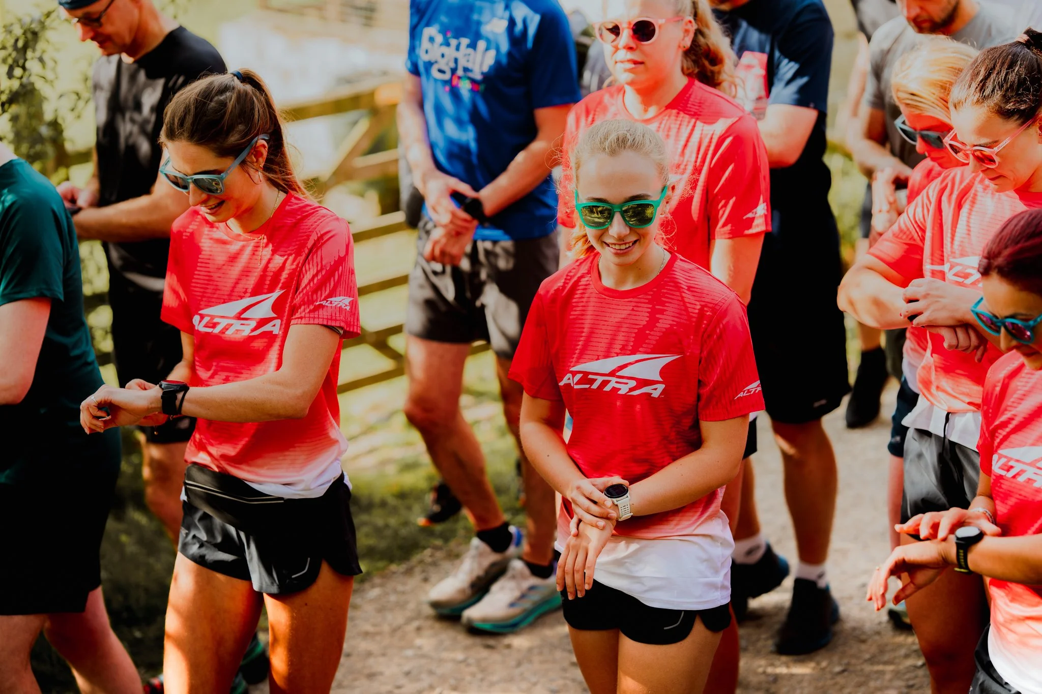 Freelance outdoor Lifestyle Photographer Group of people in athletic clothing, gathered outdoors, likely preparing for or participating in a running or fitness event.